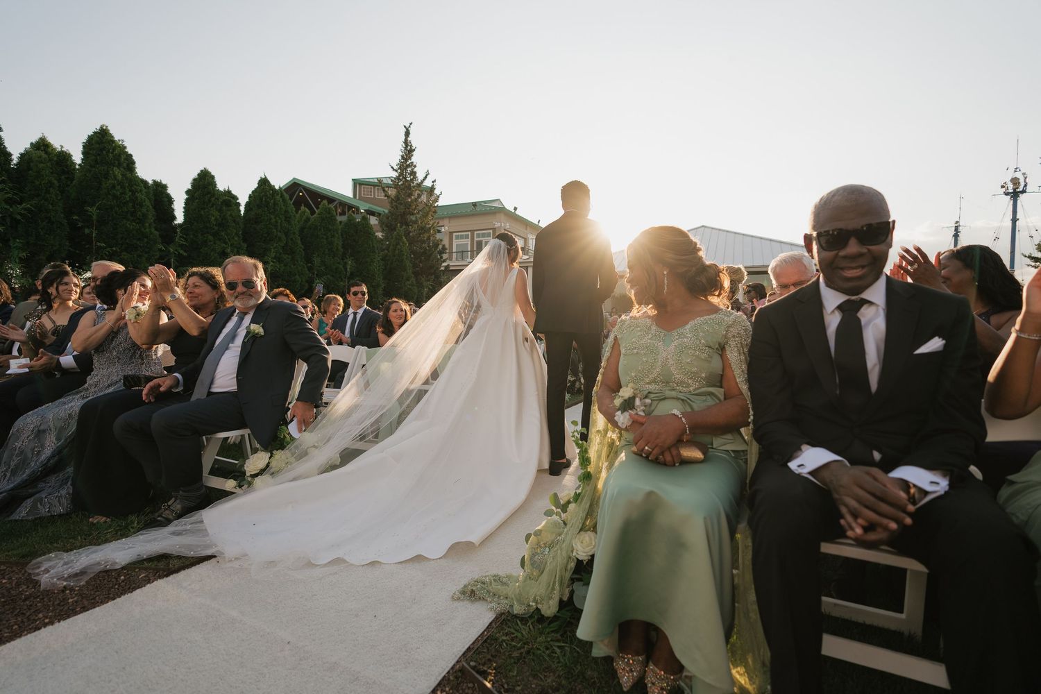 A series of outdoor wedding photos showing guests celebrating during golden hour at a scenic venue.