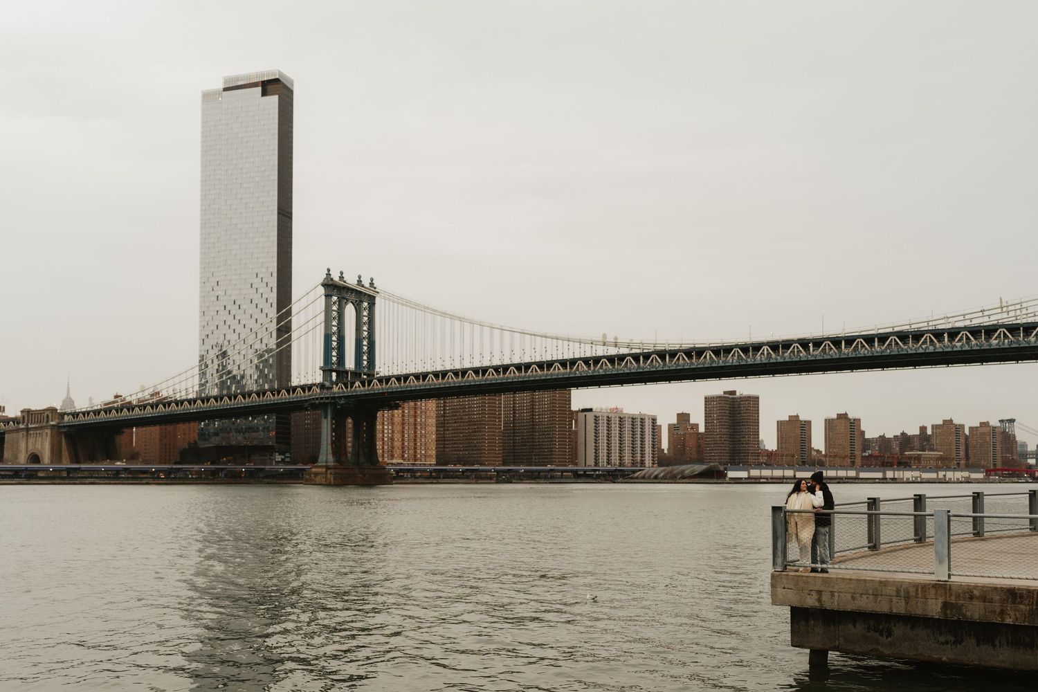 Panoramic view of the Verrazano Bridge connecting Staten Island to Brooklyn on a foggy day over New York Harbor.