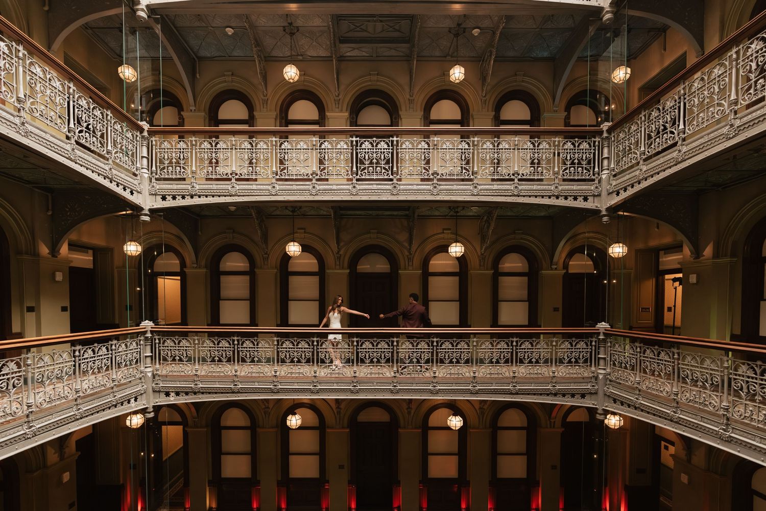 Grand historic building interior with ornate balconies and architectural details.