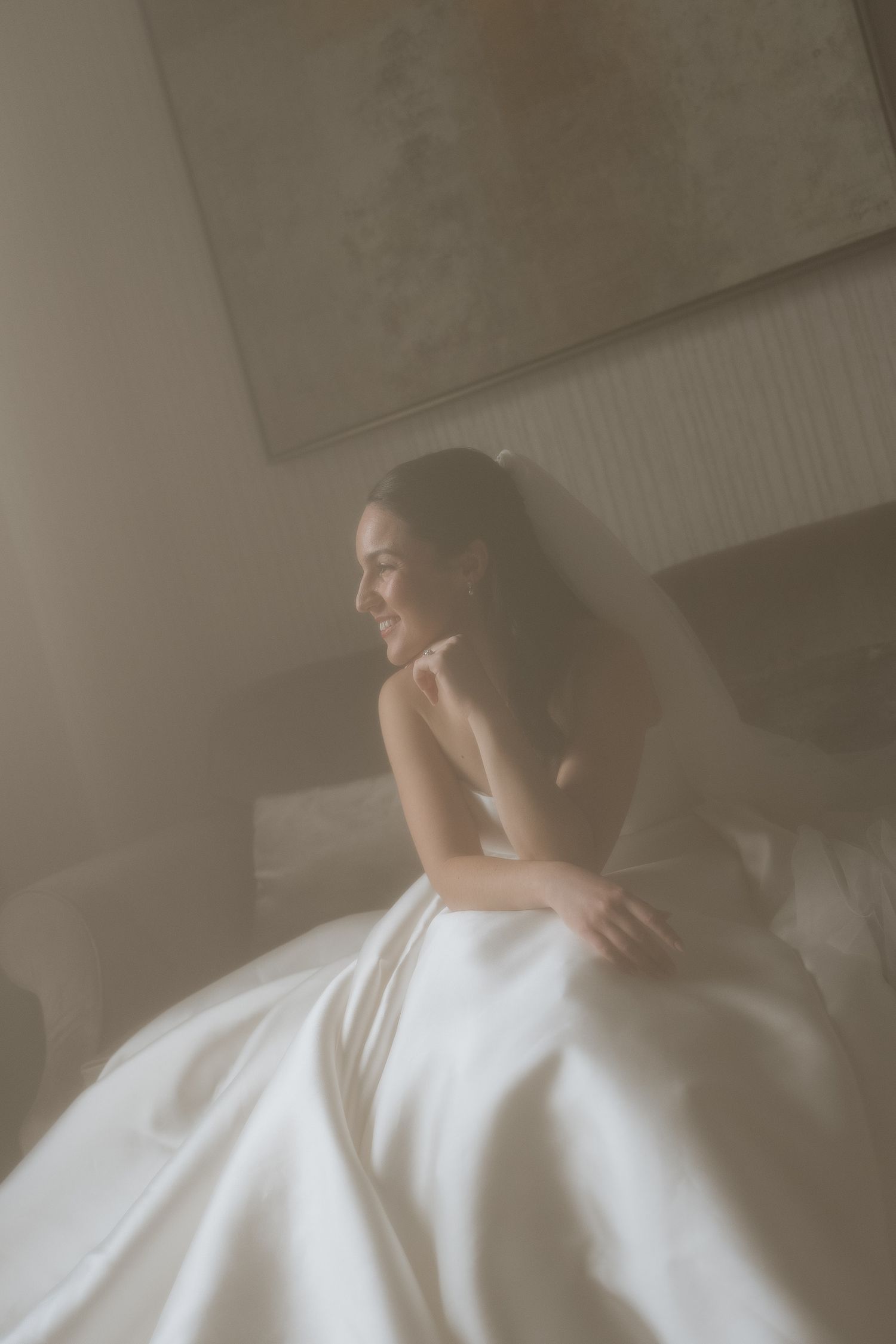 Artistic bridal portrait with soft focus and ethereal lighting.