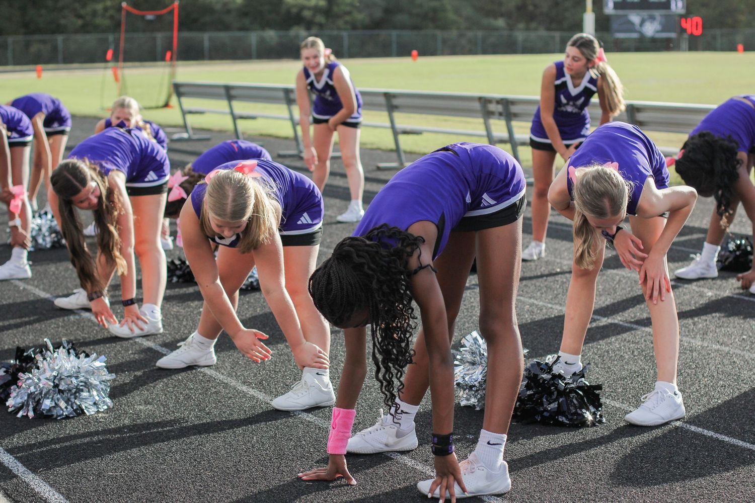 Cheerleaders stretching and warming up before a game at Weddington High School in Matthews, NC.