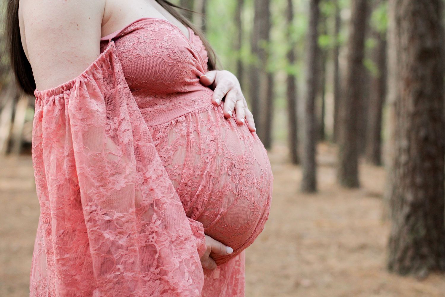 Close up of a pregnant woman's belly during a maternity session at Purser Hulsey Park.