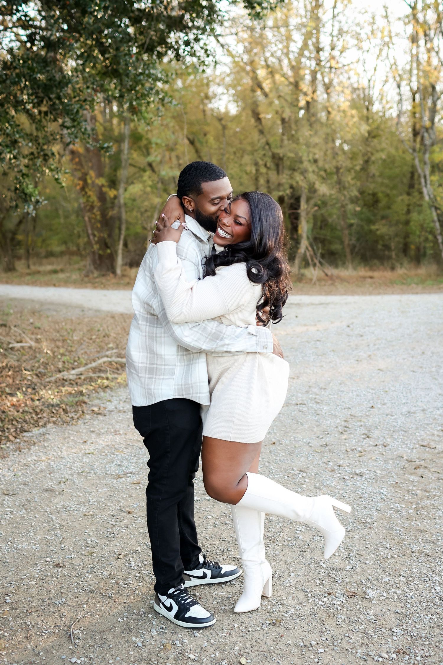 Outdoor couple photography at McAlpine Creek Park featuring a romantic kiss and hugging.