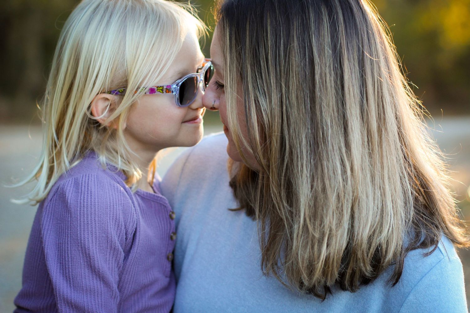 Sweet moment of a mom and daughter nose-to-nose during a Charlotte lifestyle photo session.