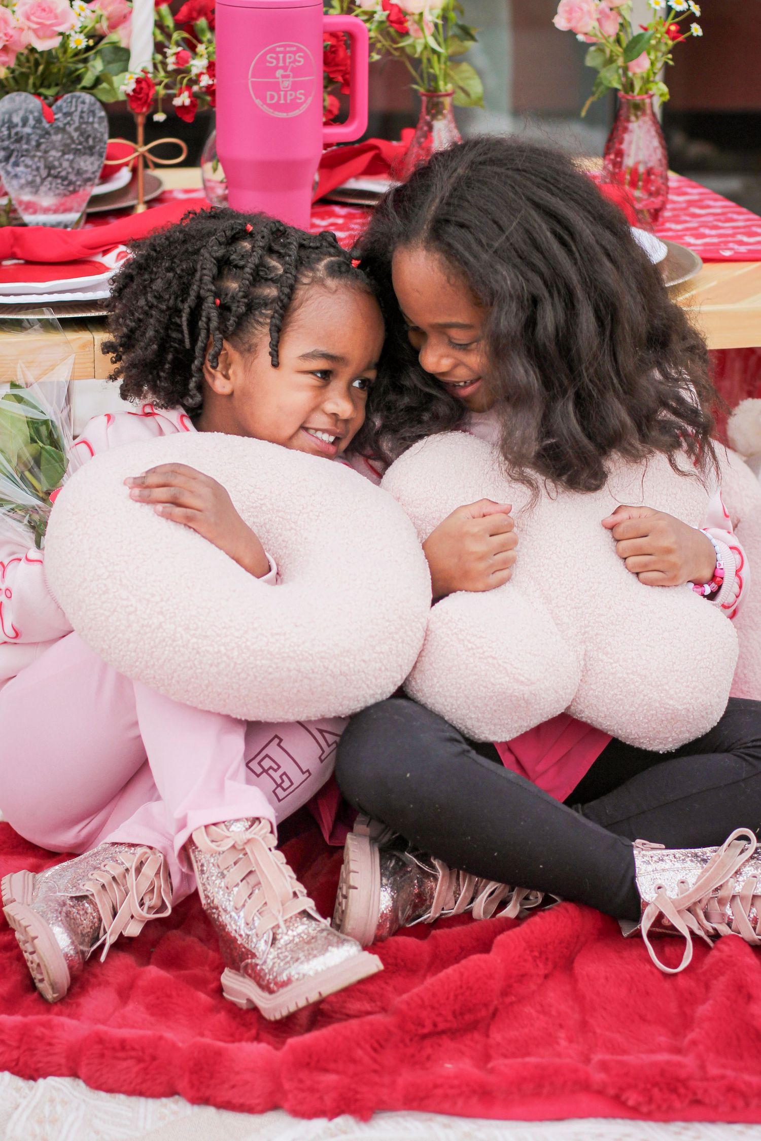 Two sisters snuggled up for a sibling photo session in the Ballantyne area.