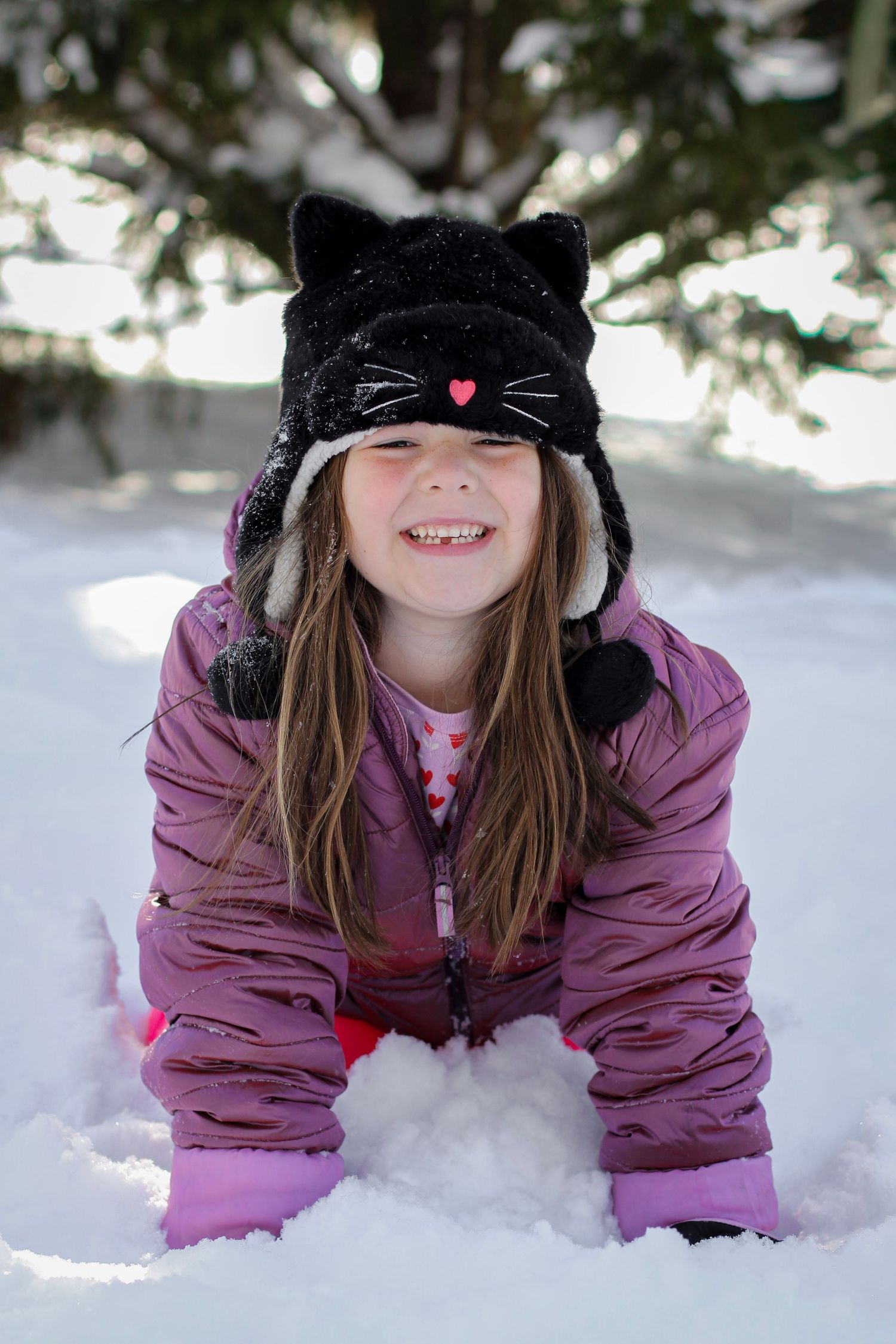 Little girl playing in the snow during a winter portrait session in Indian Trail, NC.