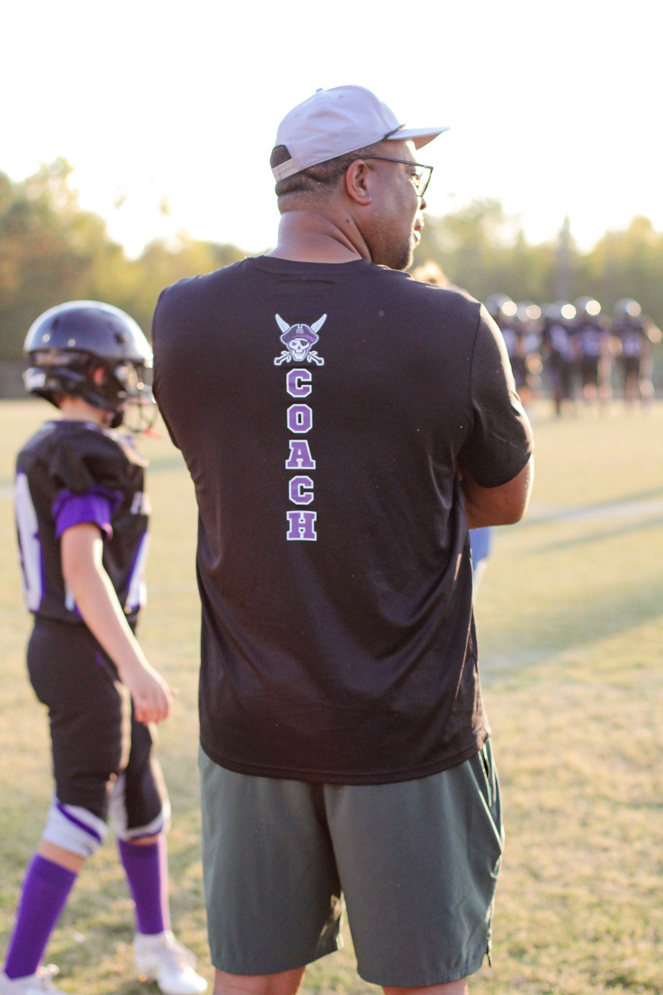A coach watching his football players intently during a game at Sun Valley High.