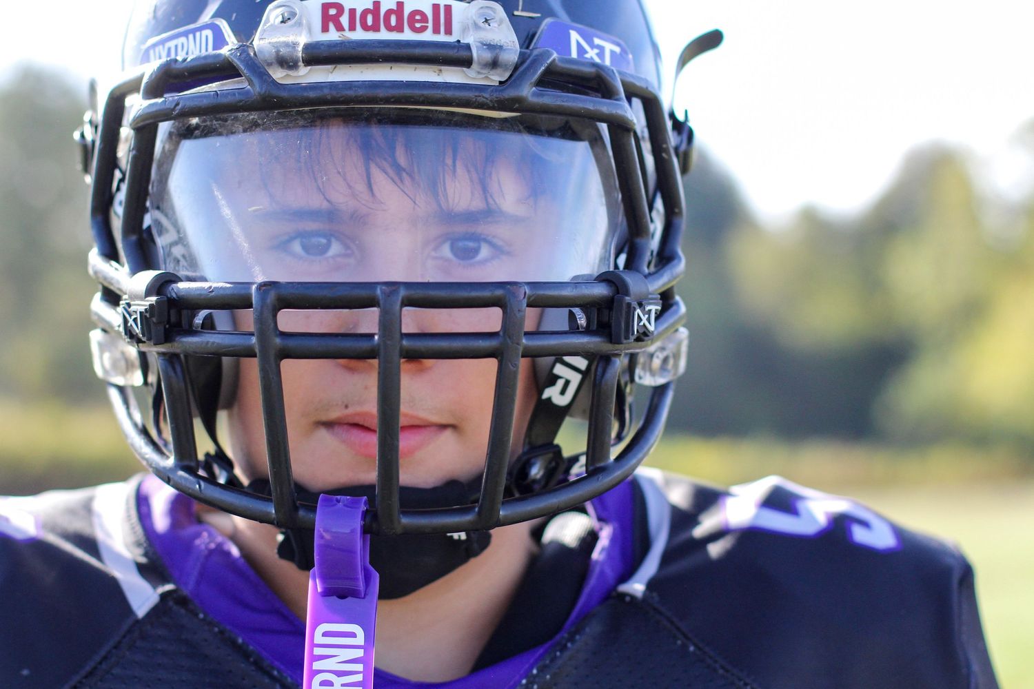 High school football player posing for a senior portrait at Independence High School.