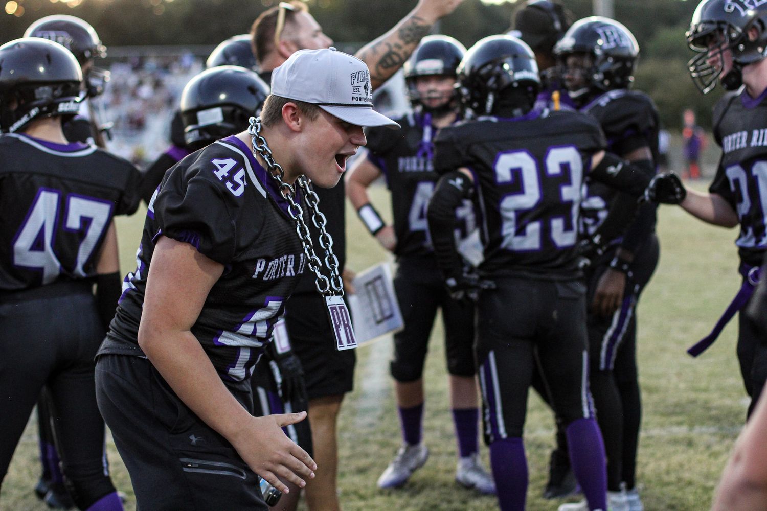 Football players excited about a play on the sidelines at Porter Ridge Middle School.
