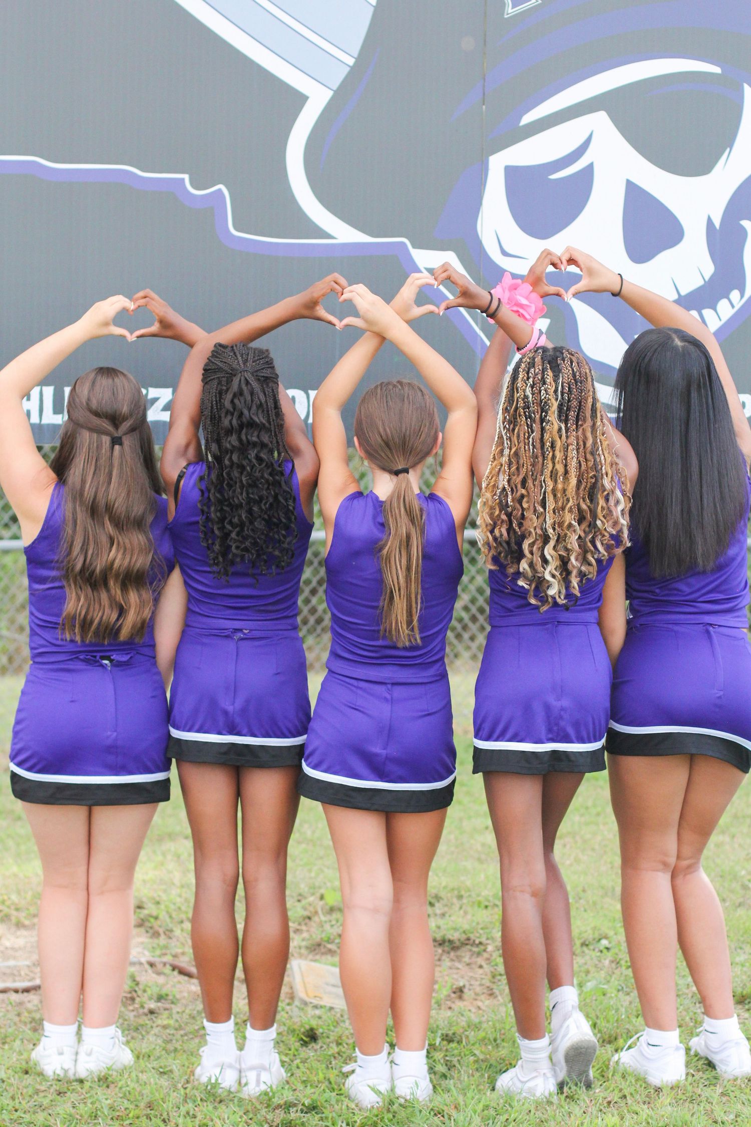 Cheerleading squad posing with heart hands in Indian Trail, NC.