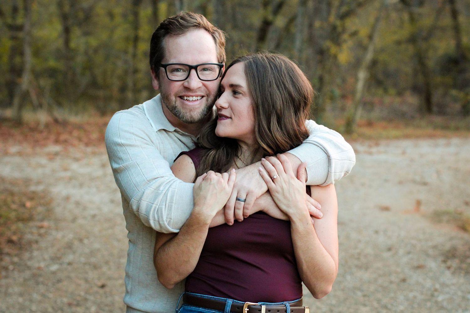 Married couple with arms around each other at McAlpine Creek Park by Aurora Glow Photo.
