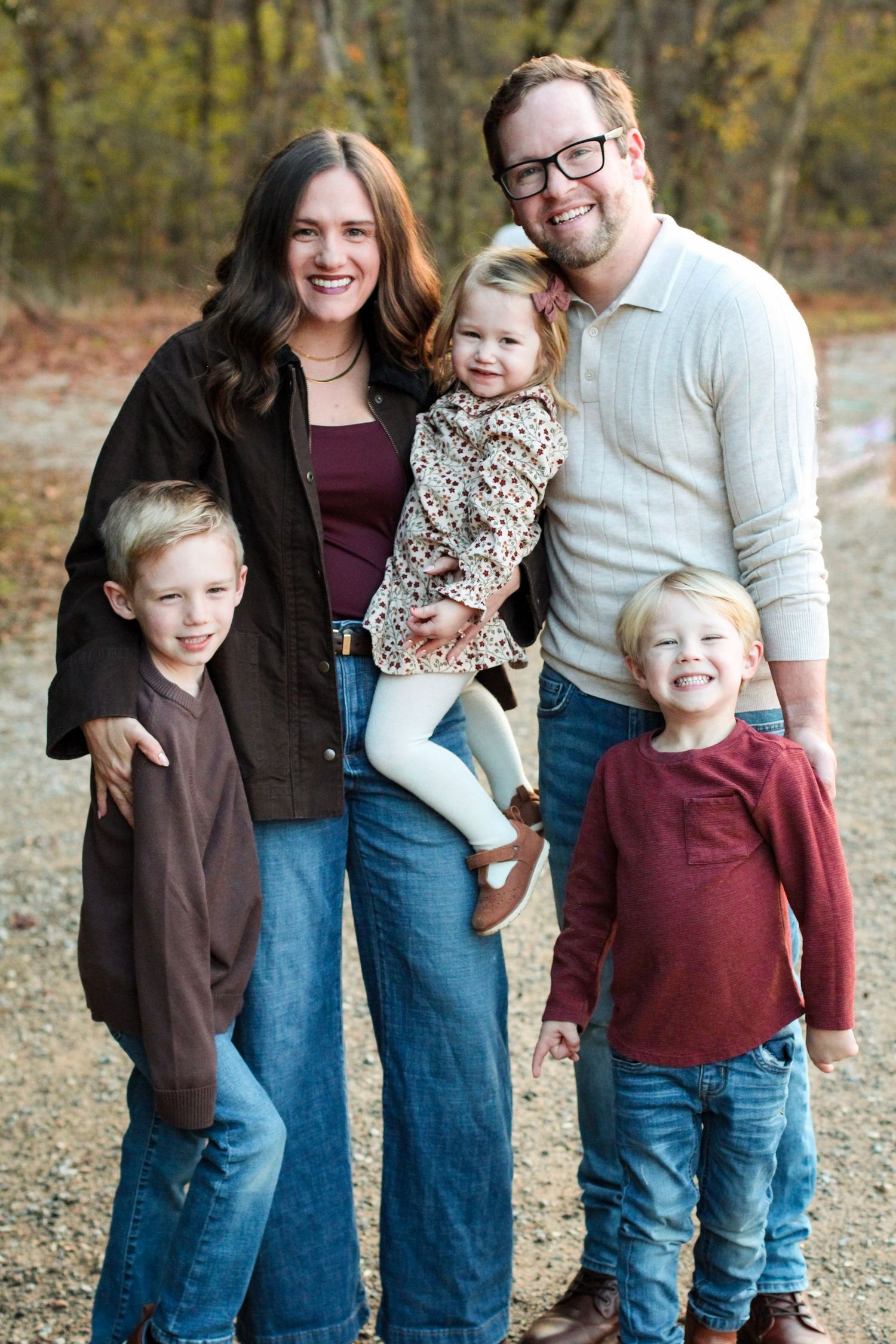 Family of five posed for professional family photos at McAlpine Creek Park.