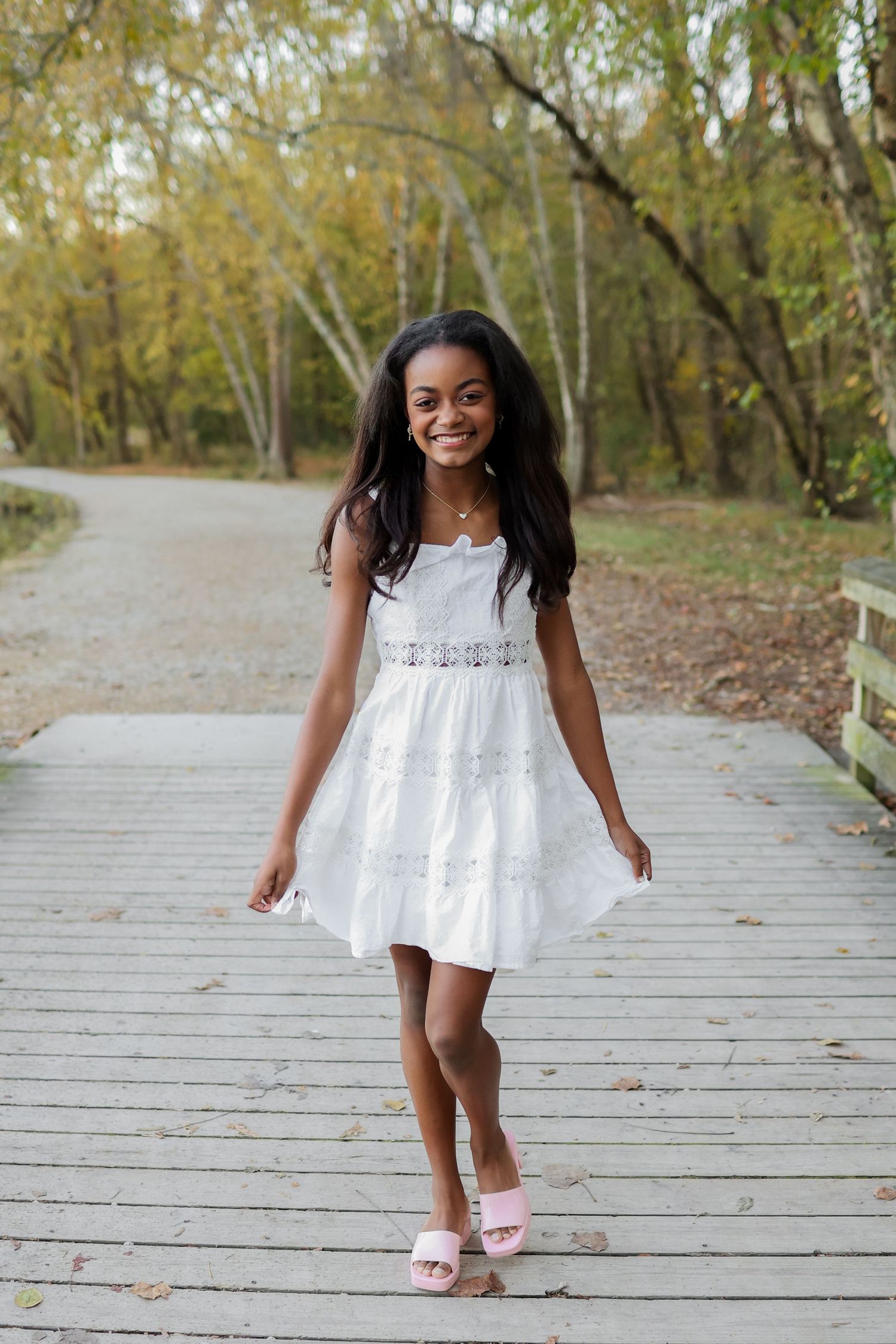 8th grade girl posing for middle school portraits on a bridge in Charlotte, NC.