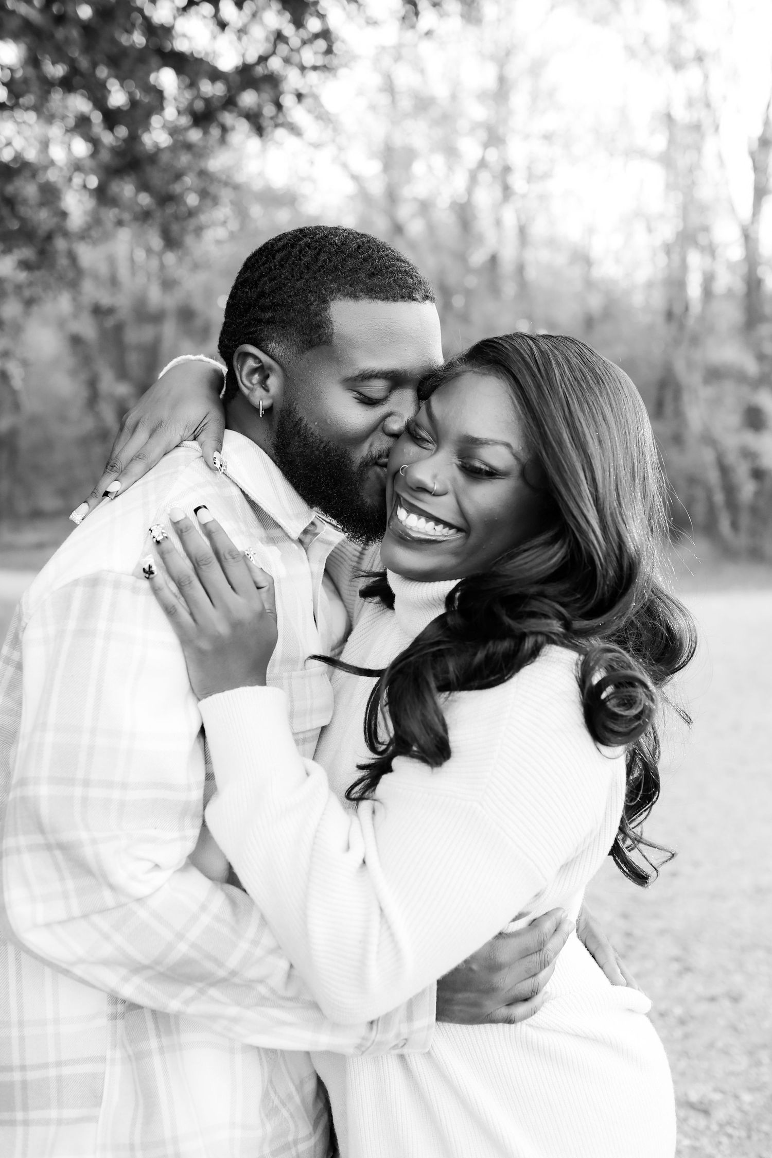 Happy couple laughing and hugging during an engagement session by Aurora Glow Photo at McAlpine Park.
