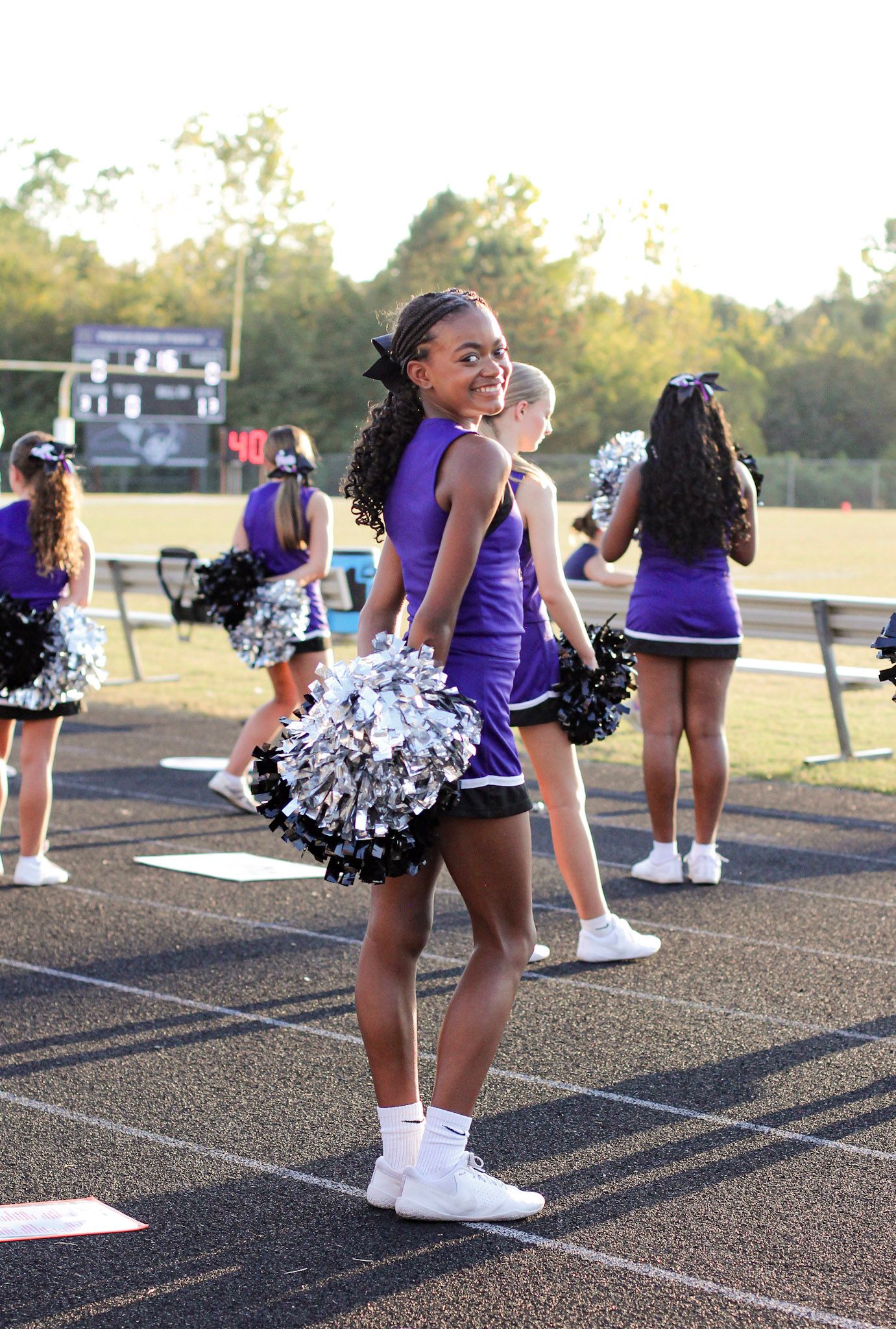 Middle school cheerleader posing at a game near Matthews, NC.