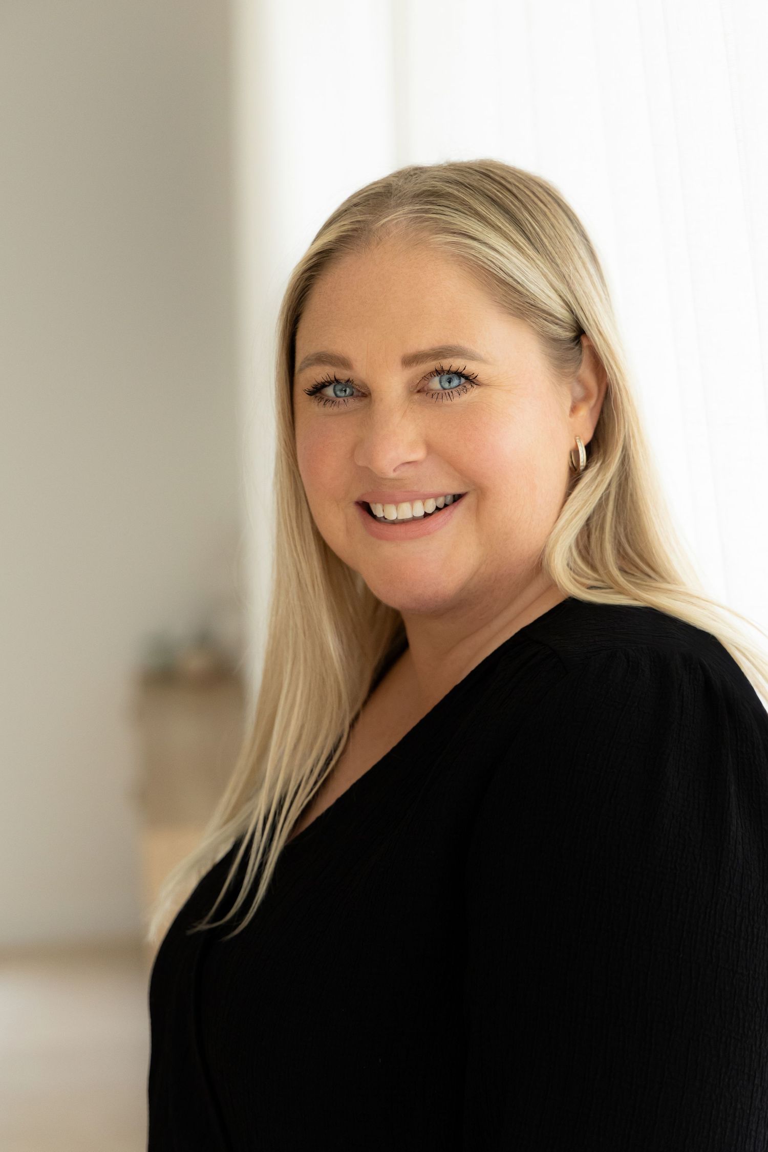 Professional headshots showing a blonde woman in a black blazer with warm expressions against a light background.
