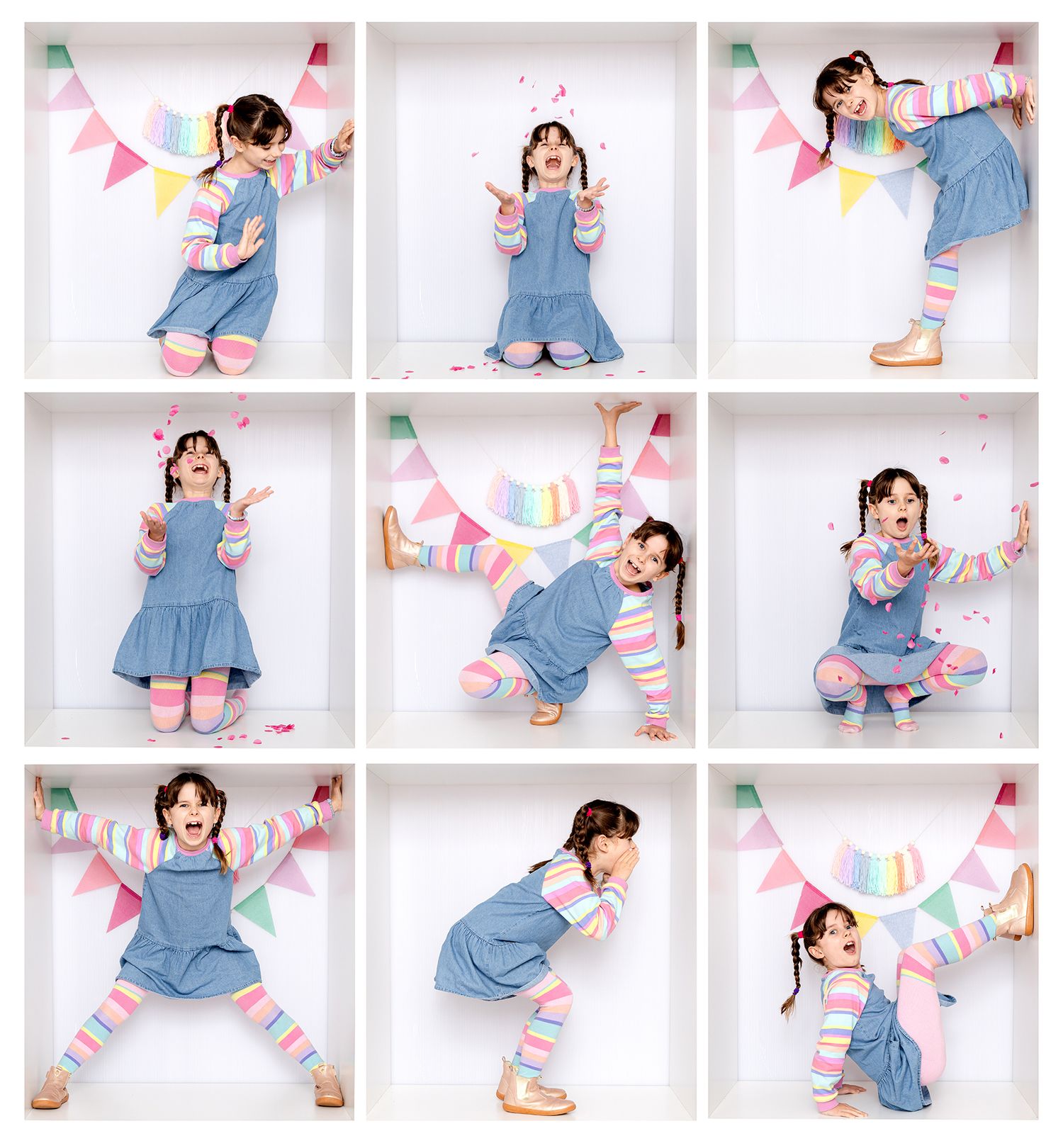 Person in denim overalls and pink shoes poses playfully with colorful paper bunting decorations in studio setting.