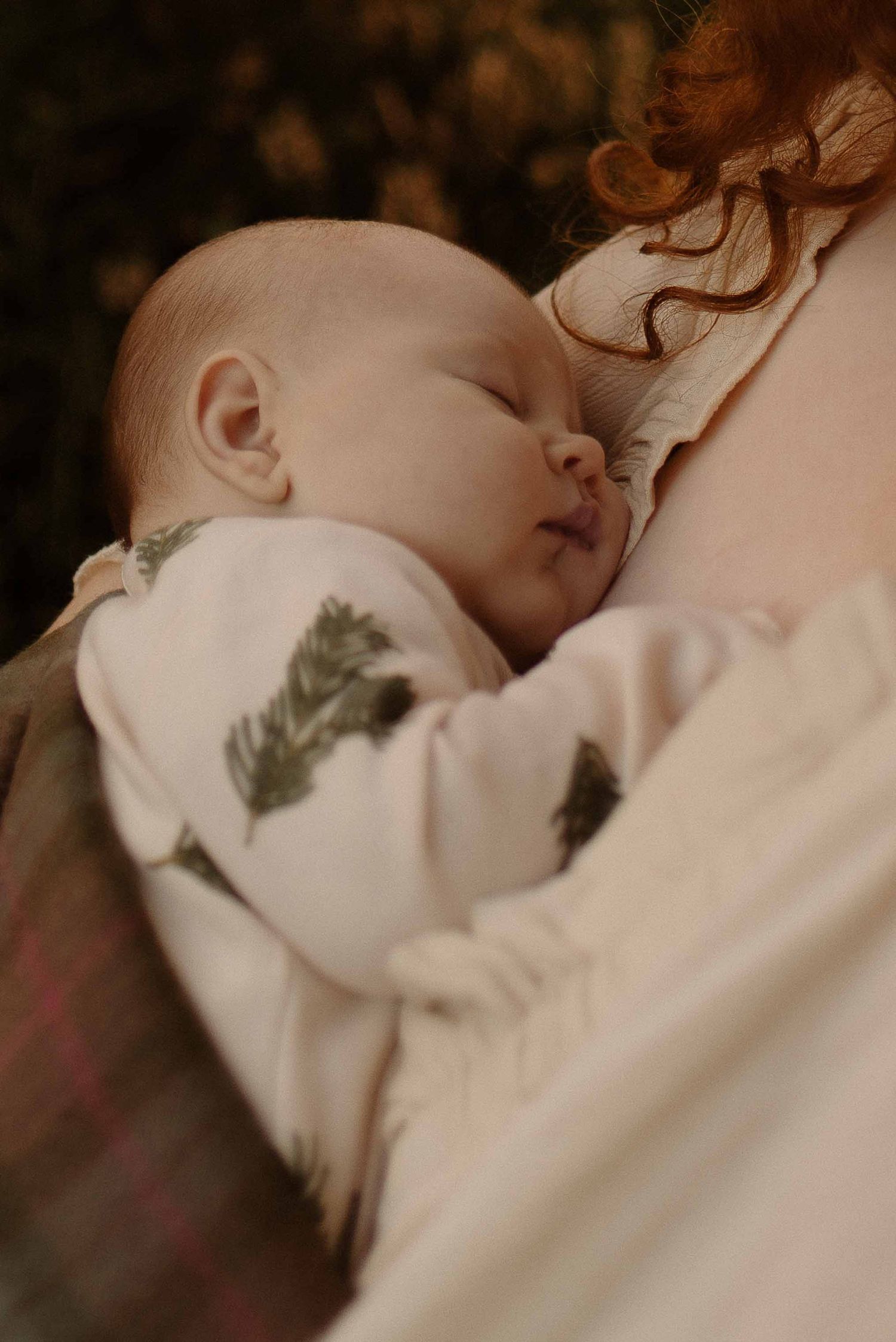 Mother holding baby close to her chest during a motherhood photoshoot at Healey Nab, Chorley