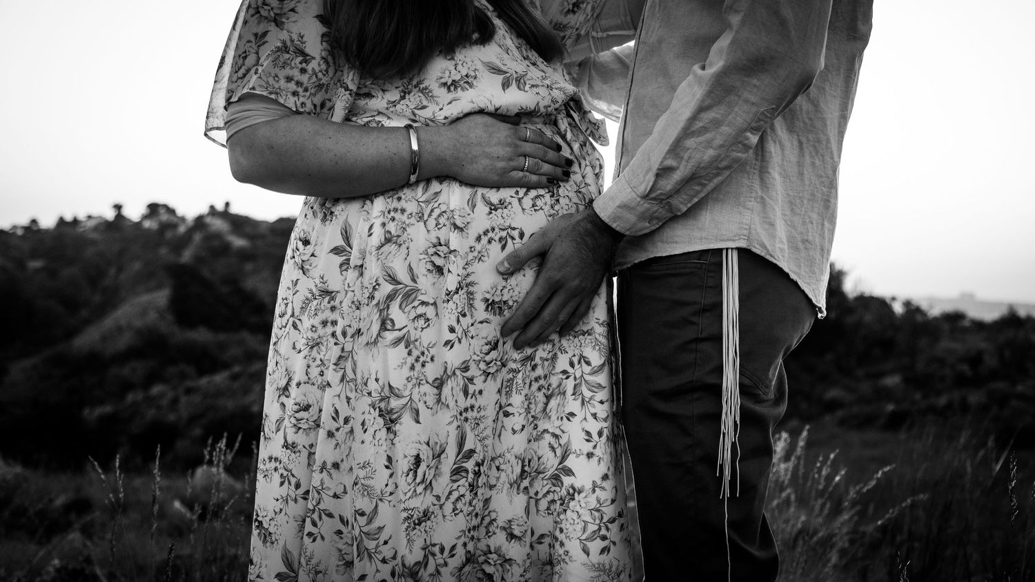 Romantic black and white portrait session in a natural outdoor setting.