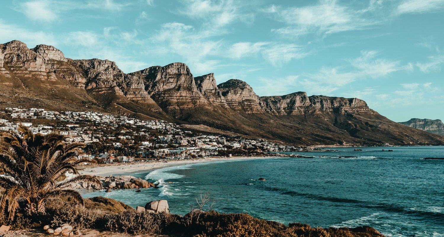 Scenic coastal view of mountains and beach in Cape Town with turquoise waters.