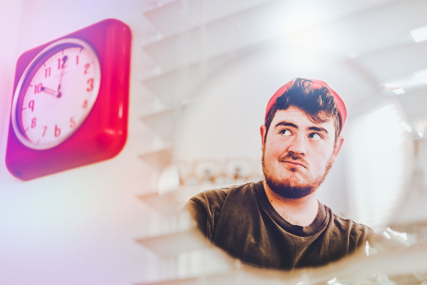 Creative portrait with pink clock decorations in soft dreamy lighting.
