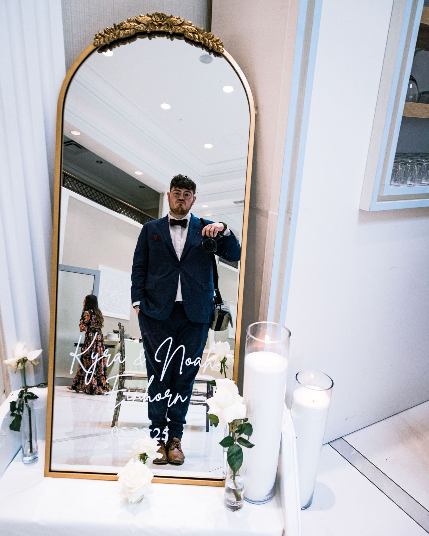 Wedding preparation scene in an elegant room with ornate gold-framed mirror.