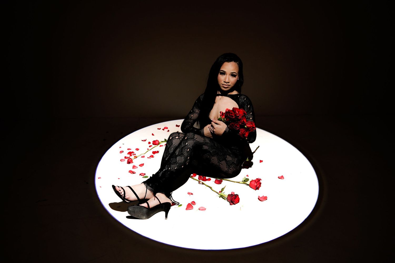 Artistic dark mood photography with white circular platform and dramatic lighting.