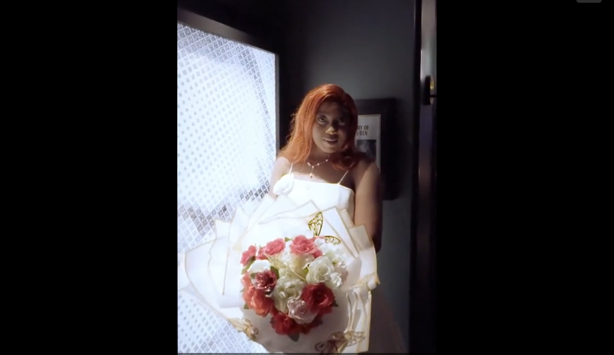 A bride in a white wedding dress holds a bouquet of pink and white roses against a dark background.