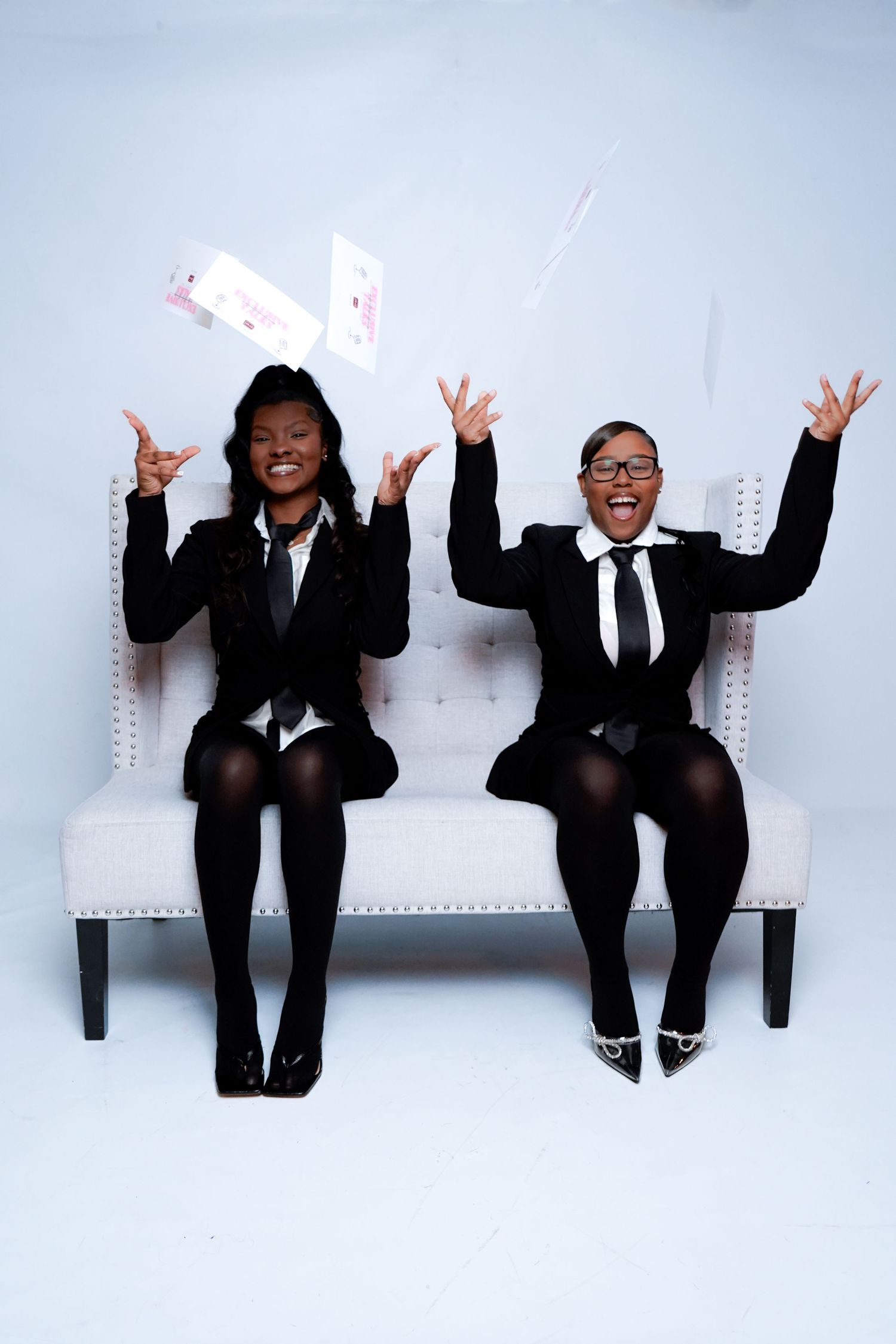 Business team in black suits sitting on bench making fun poses in sequence of four progressive shots.