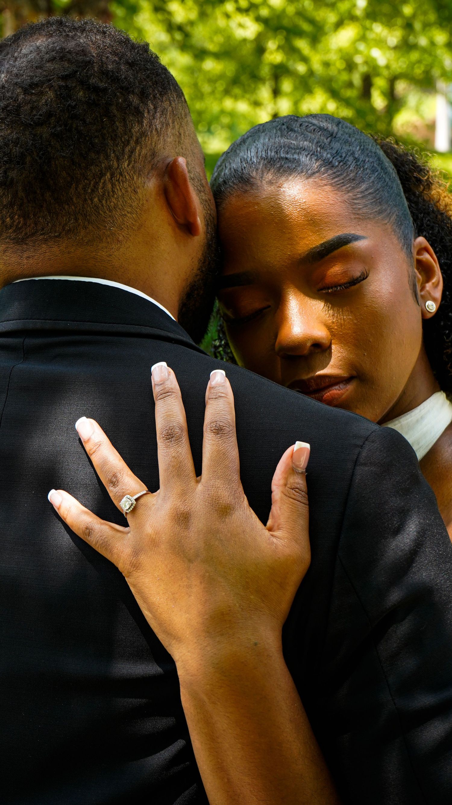 Close-up series showing an intimate embrace between a couple in formal attire against a green outdoor background.