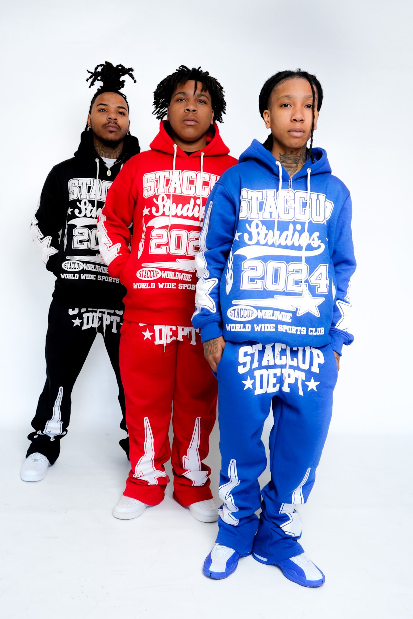 Three streetwear hoodies in black, red and blue colors shown on display.