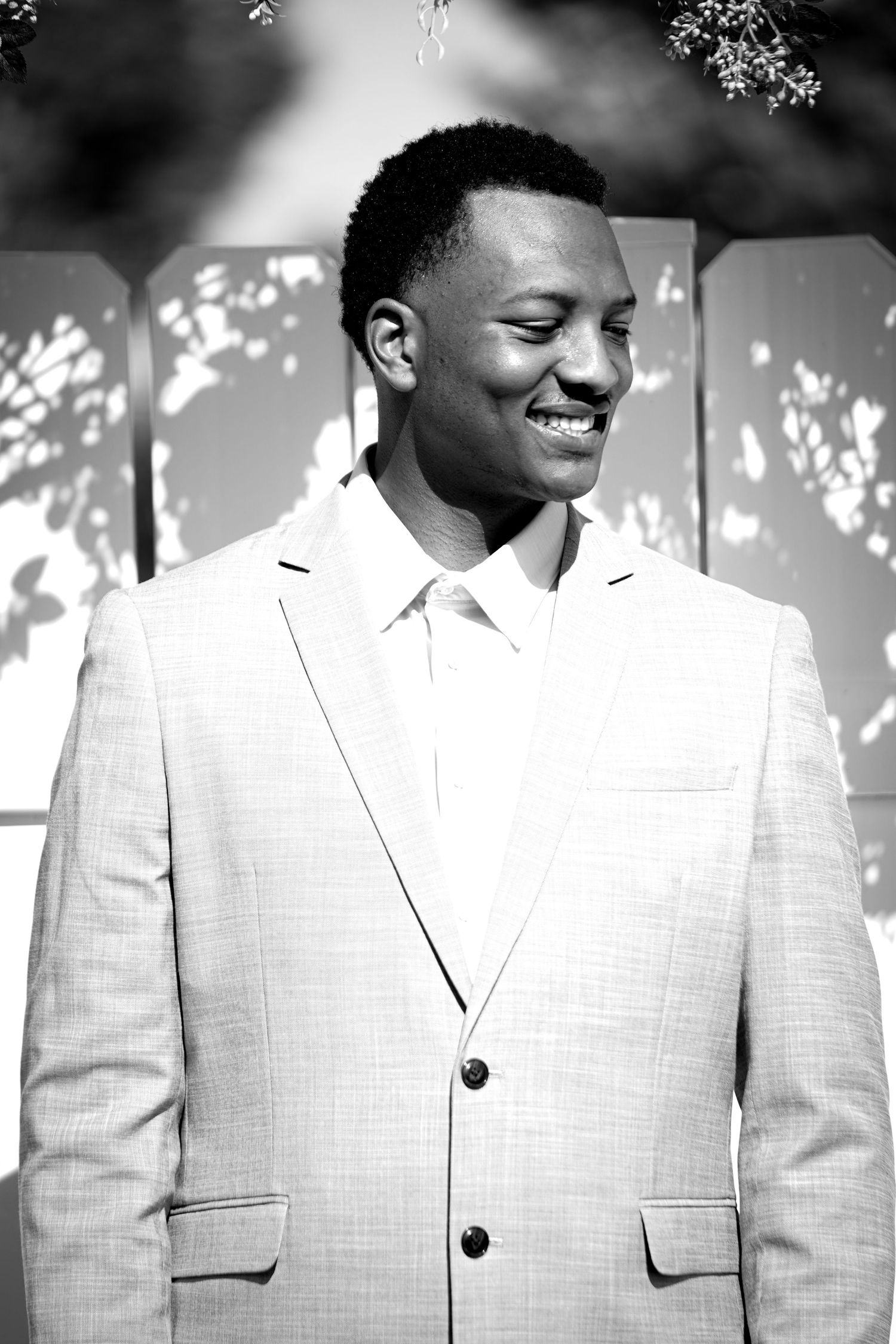 A series of candid shots showing a person in a light colored suit with dappled sunlight creating shadows.