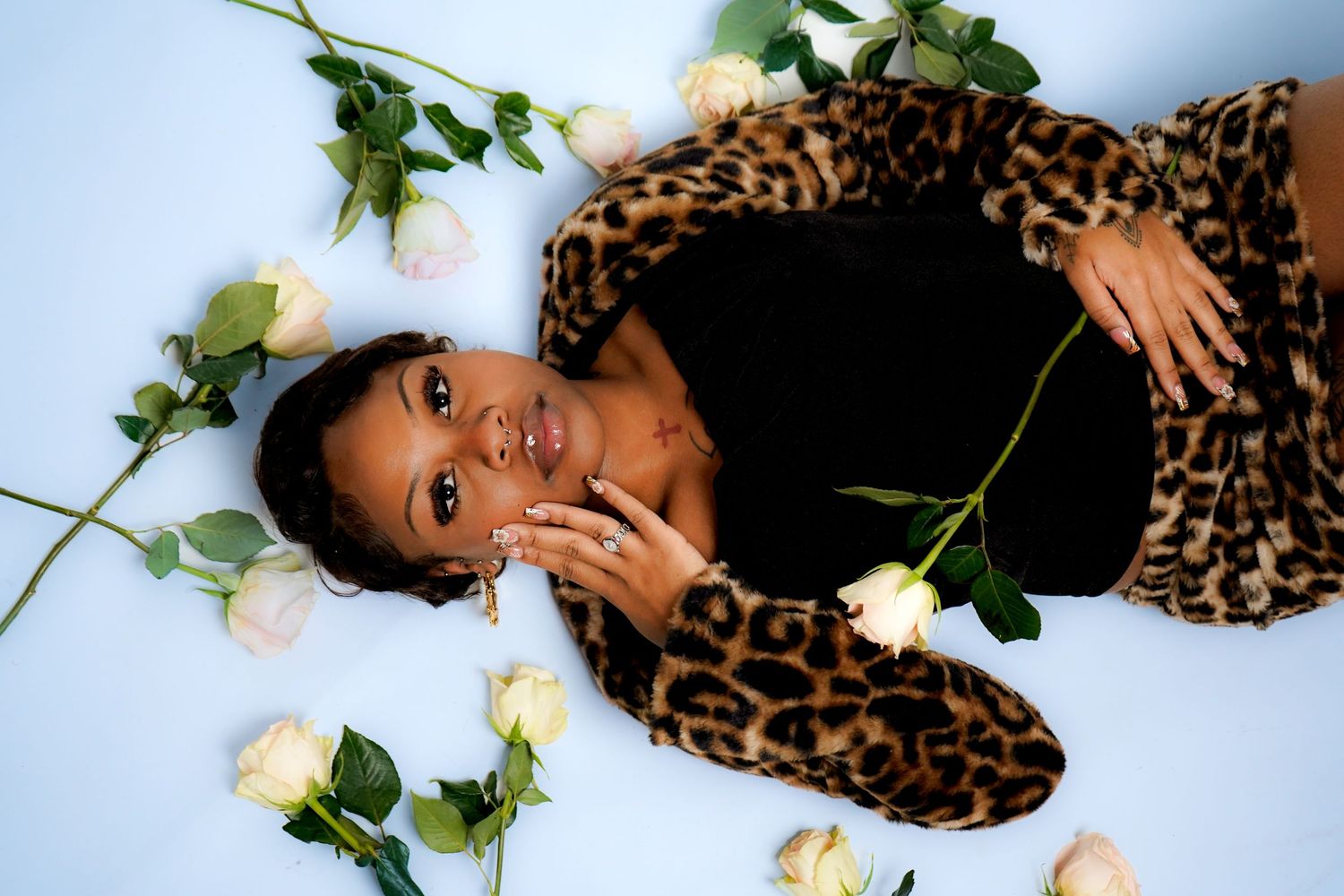 Artistic photo series with roses and leopard print against light background.