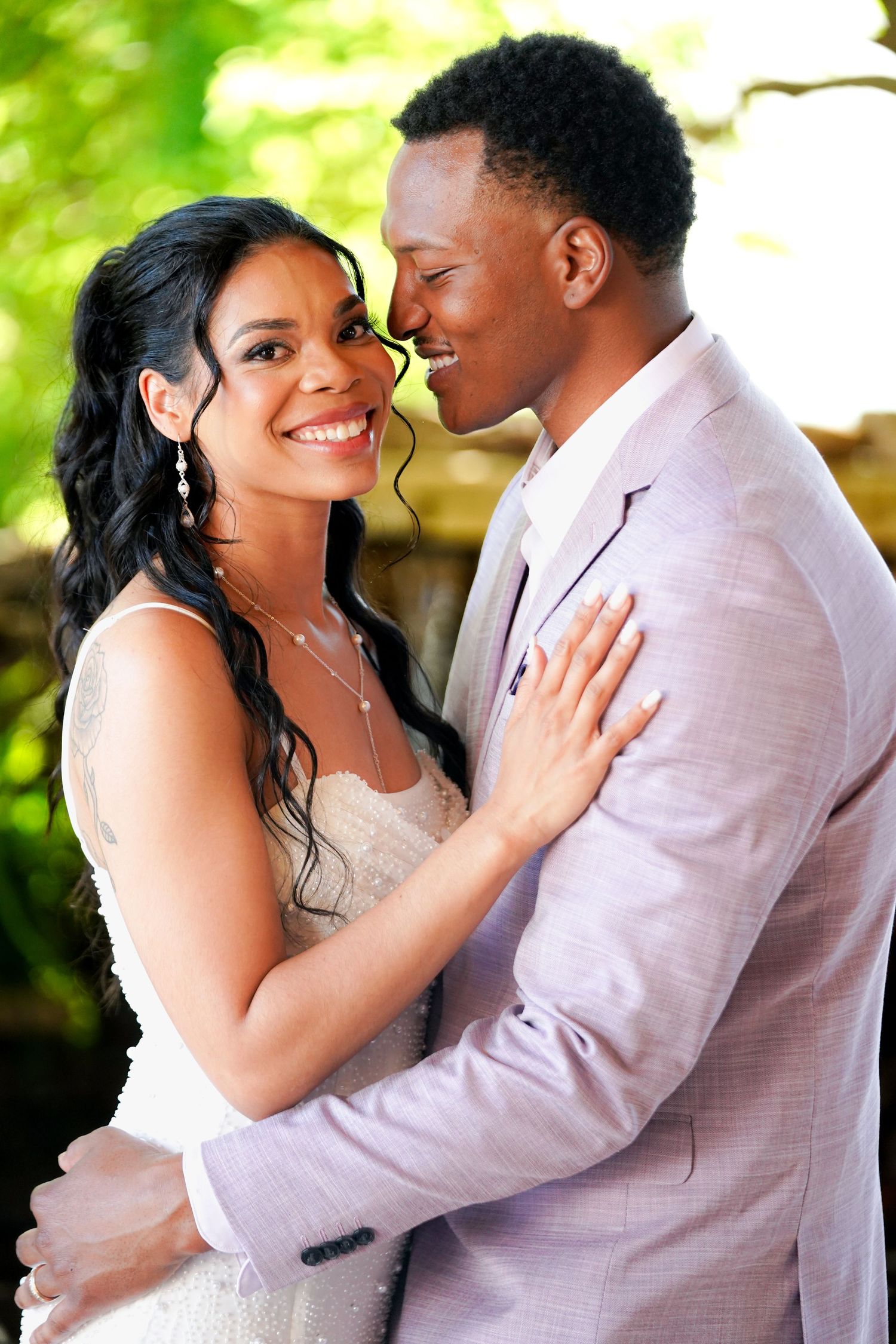 Series of romantic wedding portraits showing a couple in white and pink formal attire embracing outdoors.