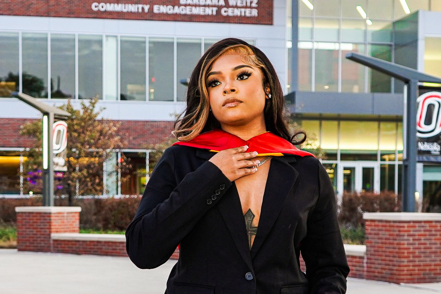 A series of graduation photos taken against a brick building exterior with columns.