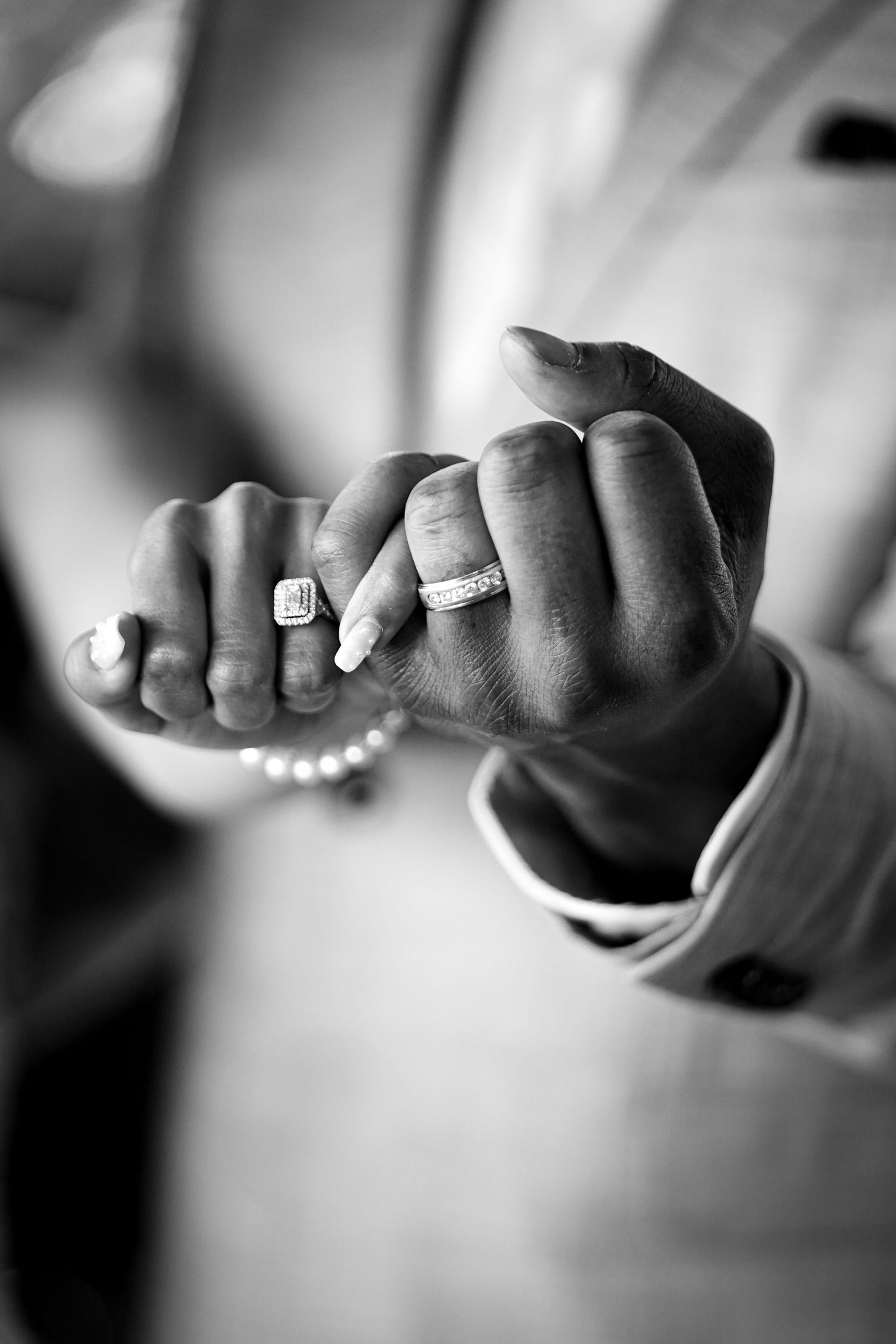 Black and white macro photographs showing wedding rings and hands in artistic detail.