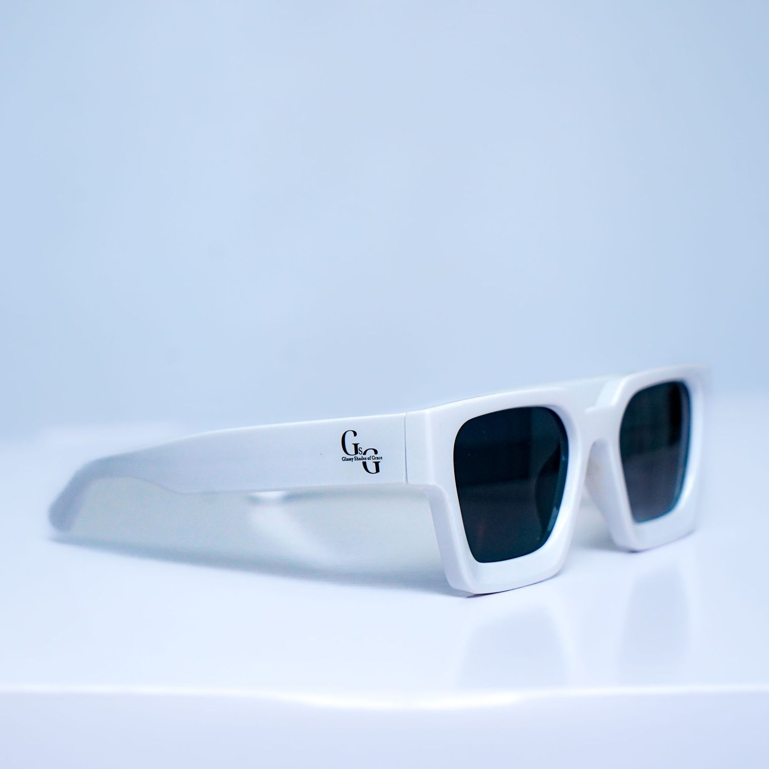 White rectangular sunglasses displayed from multiple angles on light background.