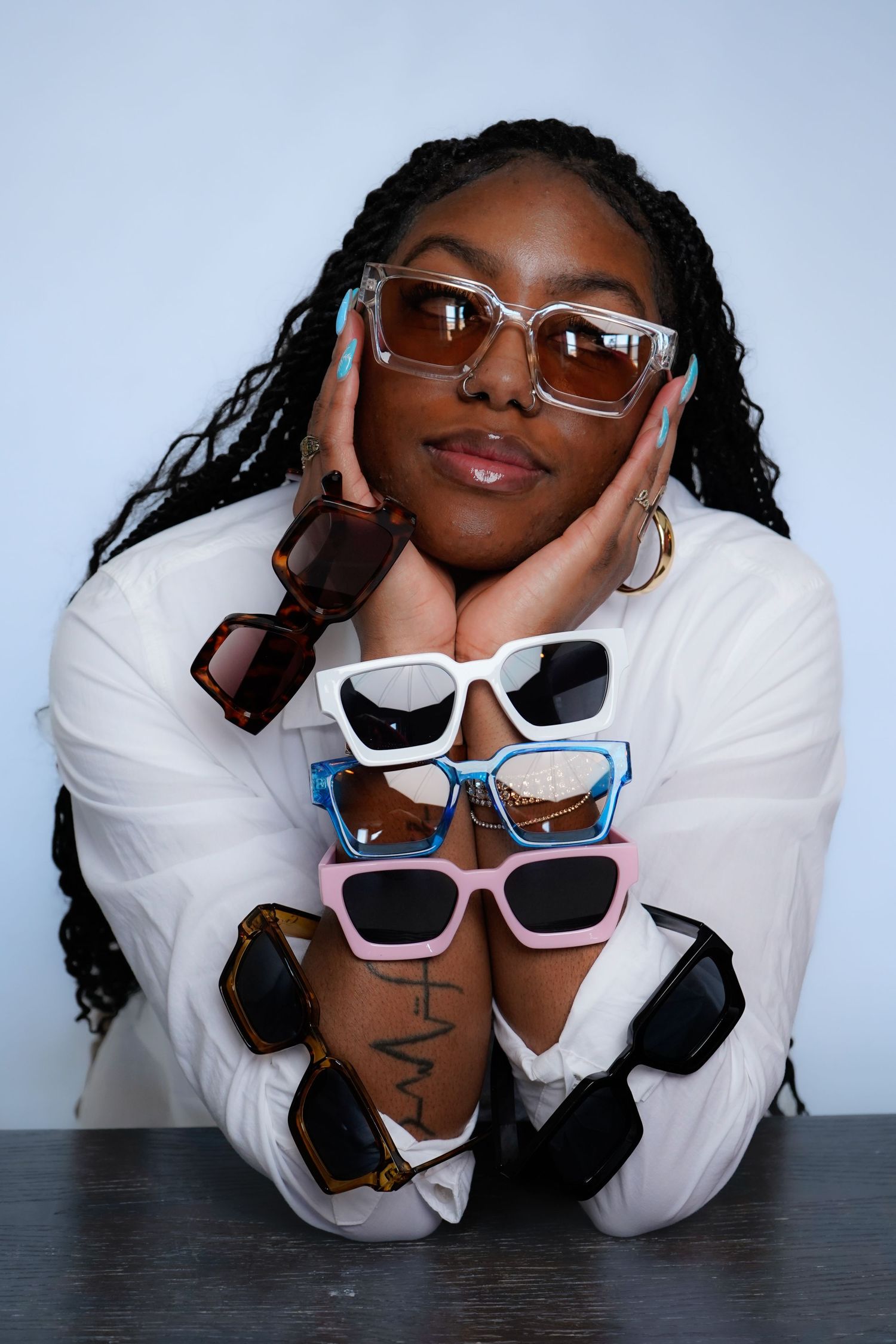Collection of fashion sunglasses displayed in creative poses on white background.