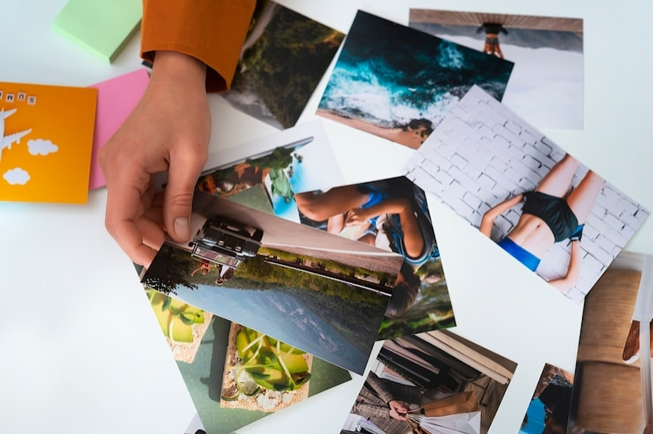 Collection of fashion photography prints laid out on white surface.