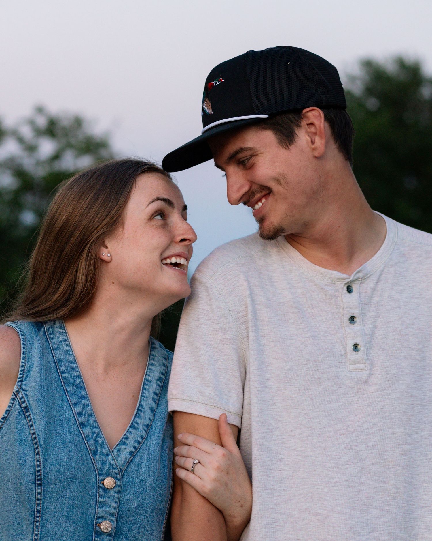 McAlester, OK couples session with field, tractor, and sunset by Edmond & OKC photographer Taylor Maze, natural light lifestyle portraits.