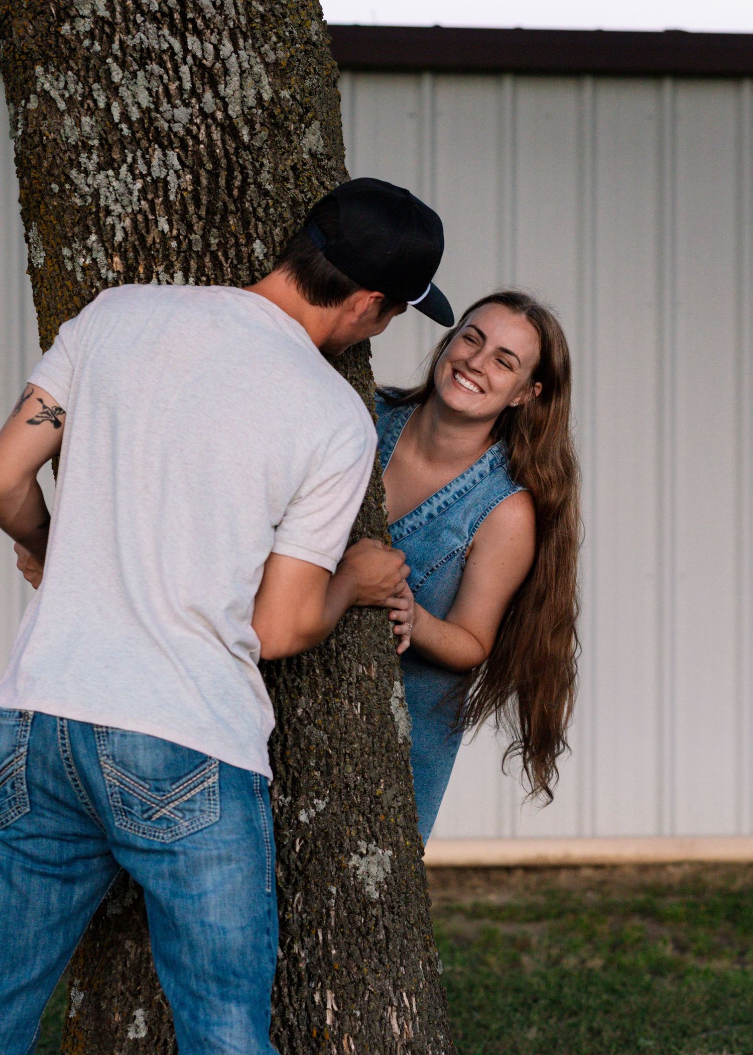 McAlester, OK couples session with field, tractor, and sunset by Edmond & OKC photographer Taylor Maze, natural light lifestyle portraits.