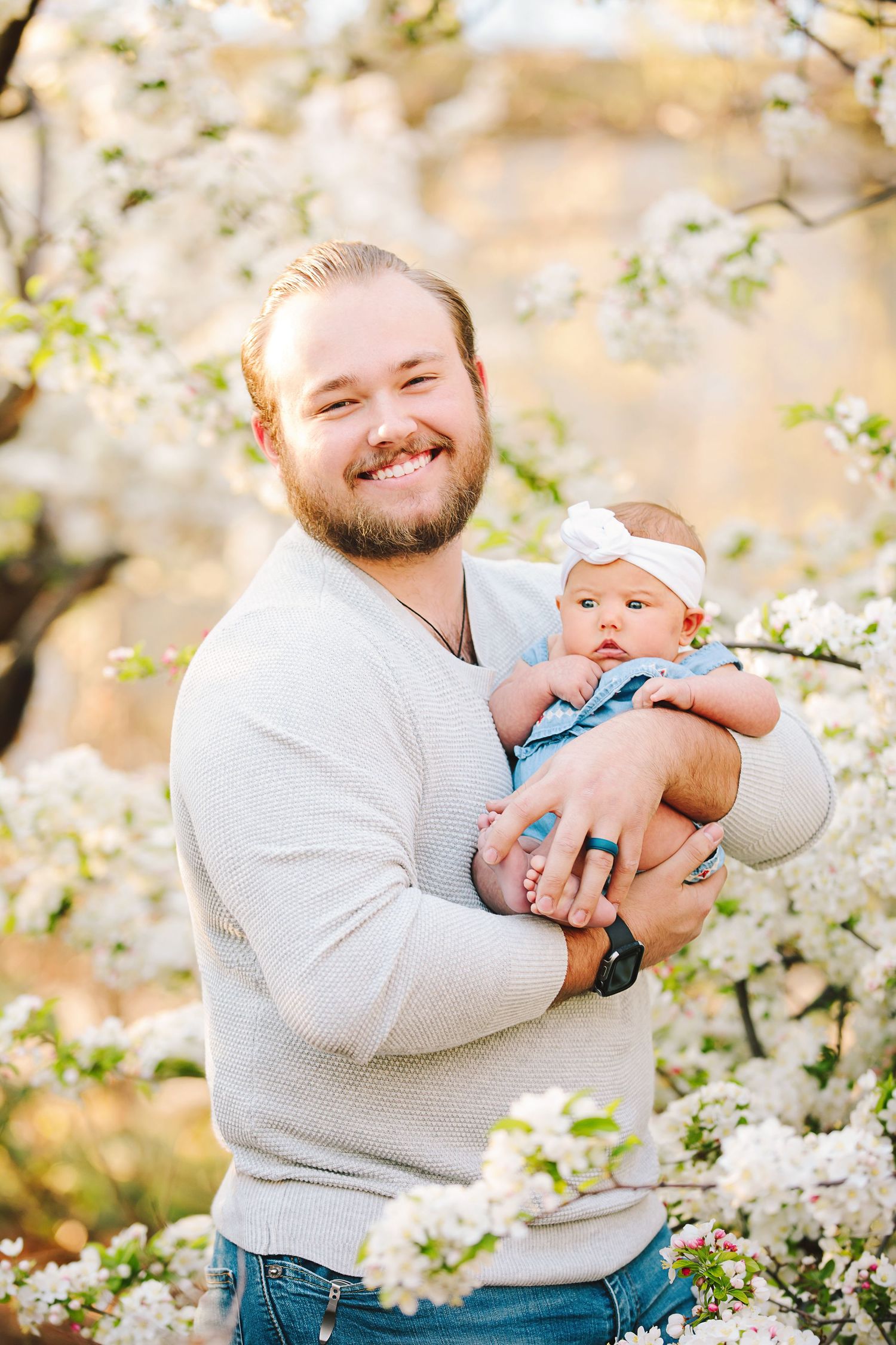 Husband and father holding newborn at Scissortail Park, OKC by Taylor Maze, Edmond & OKC photographer, natural light lifestyle portraits.
