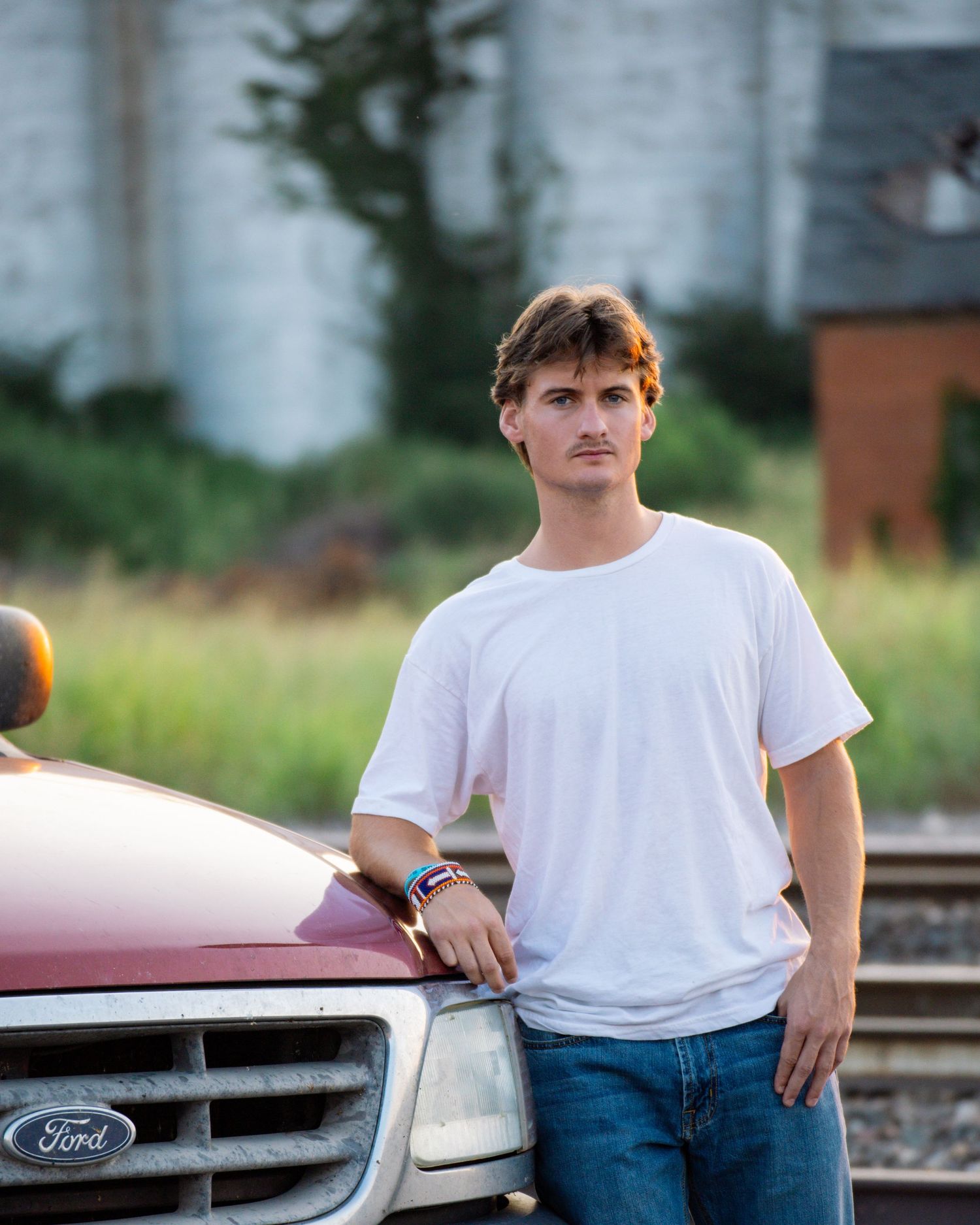Guthrie, OK senior with truck & silo, photographed by Edmond & OKC photographer Taylor Maze, natural light, true-to-color portraits.