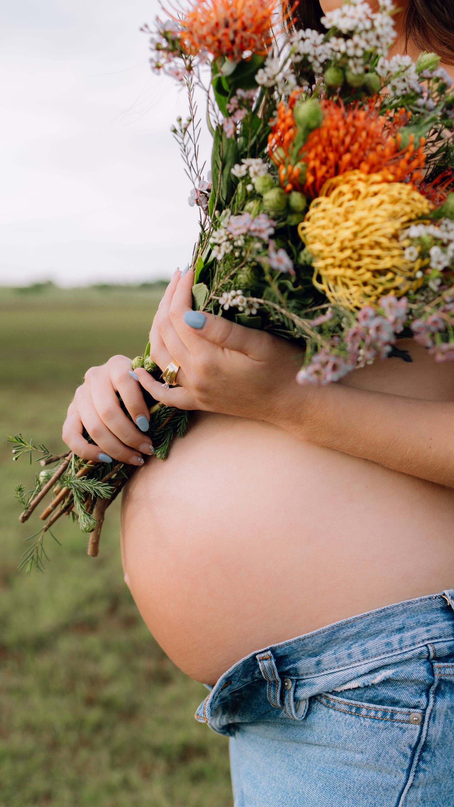 Edmond, OK maternity session in field at golden hour with flower shirt by Taylor Maze, Edmond & OKC photographer, natural light portraits.