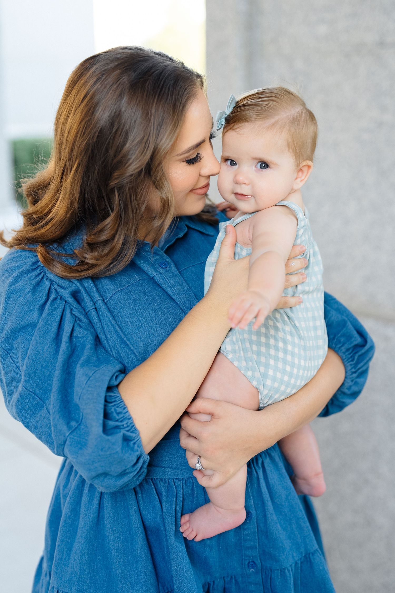 Mom whispering to her baby during golden hour session in Meridian, Idaho, photographed by Natalya Mark Photo.