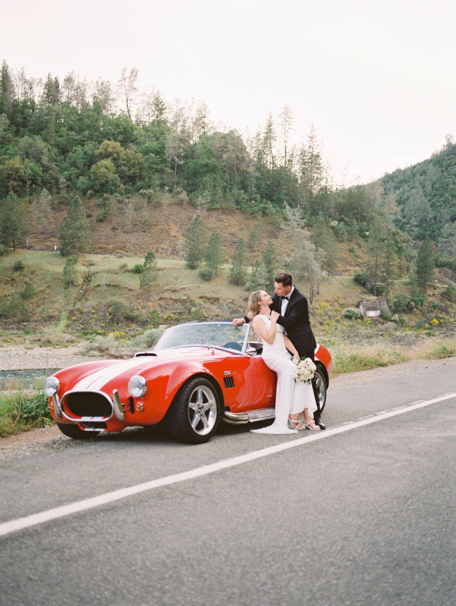 Couple laughing together during golden hour engagement session, 35mm film by Natalya Mark.