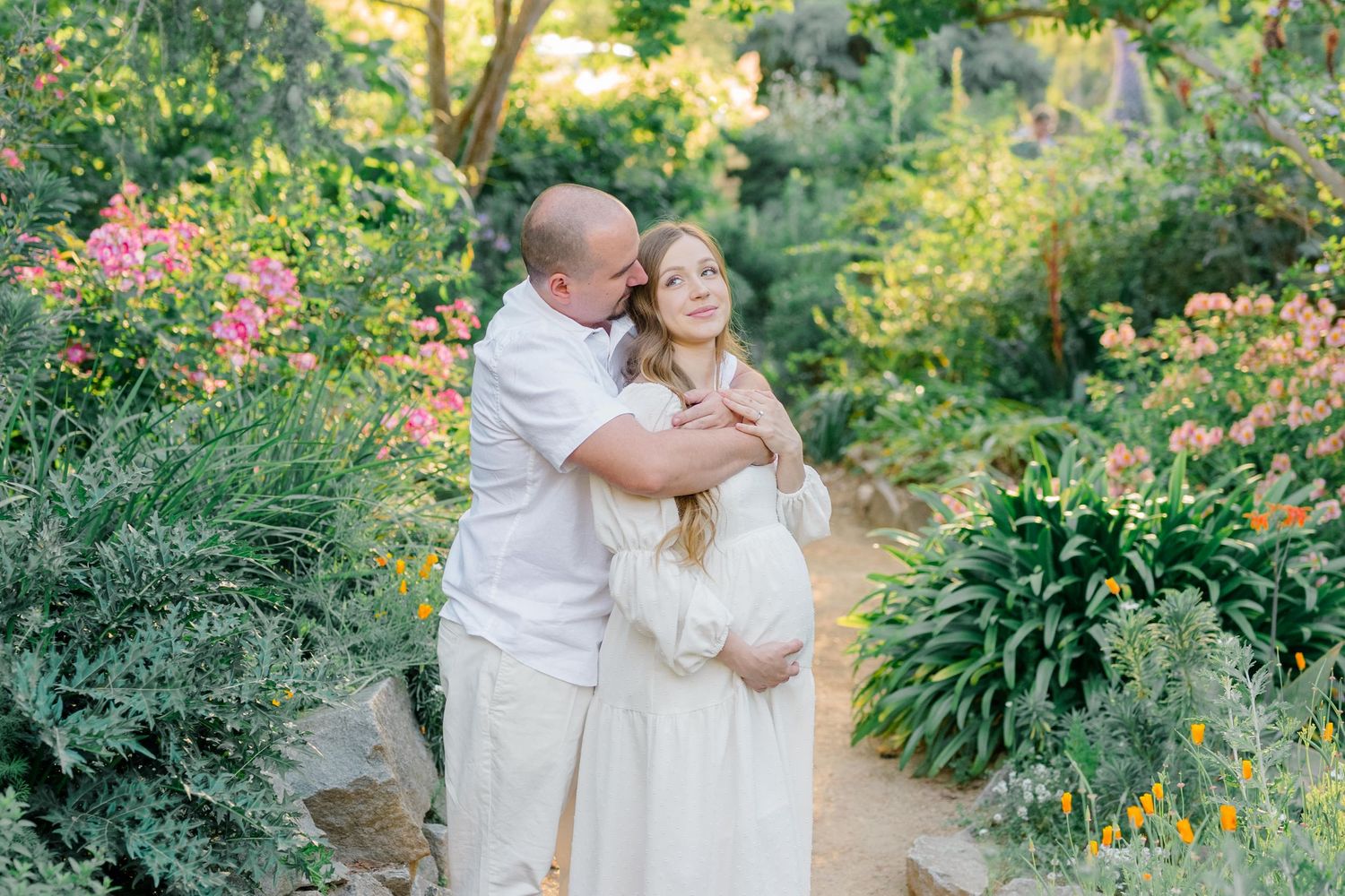 Couple standing in a wildflower field during Idaho maternity session.