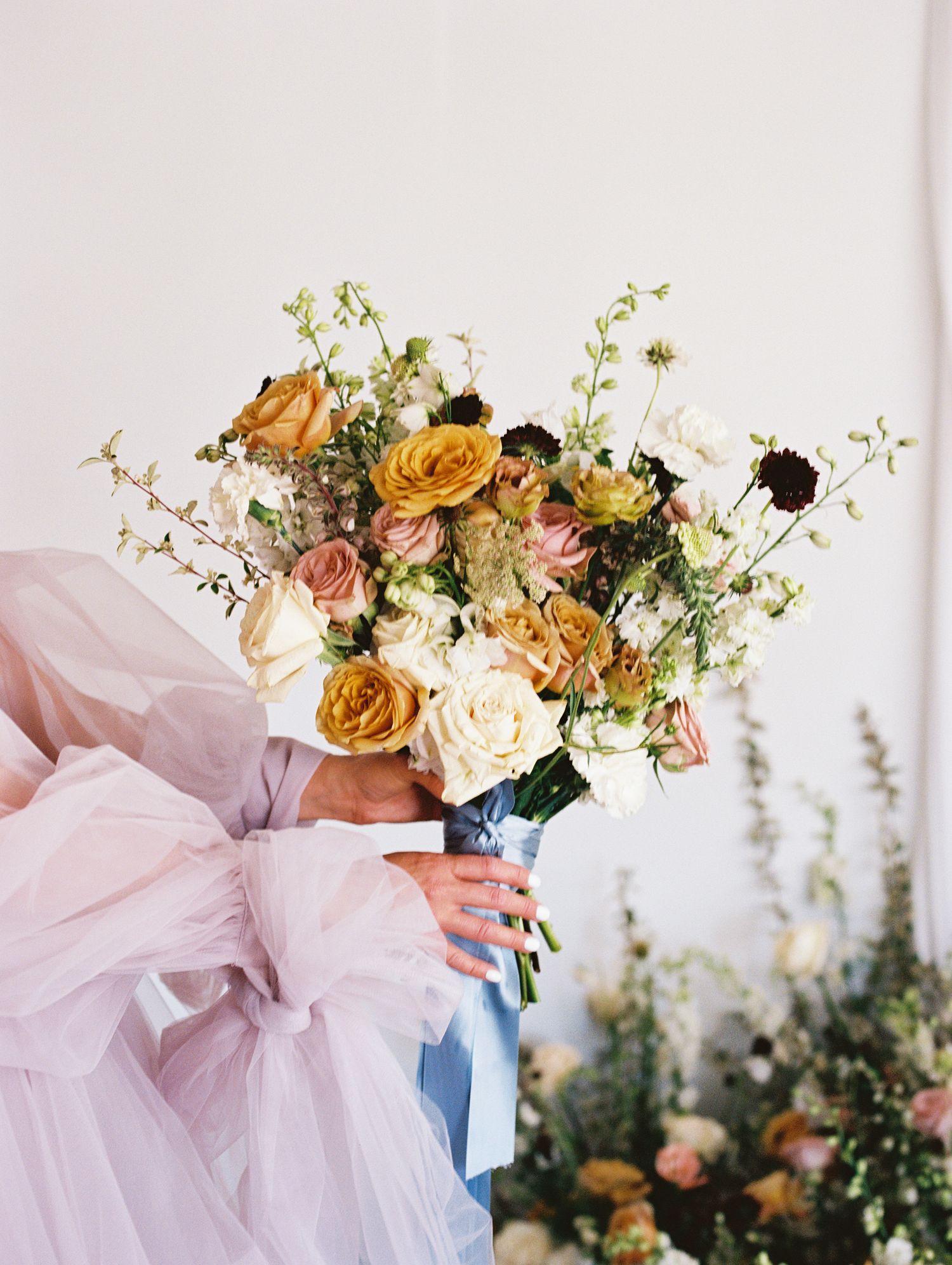 Soft bouquet of fall colored florals and greenery, taken on film by Natalya Mark Photo.