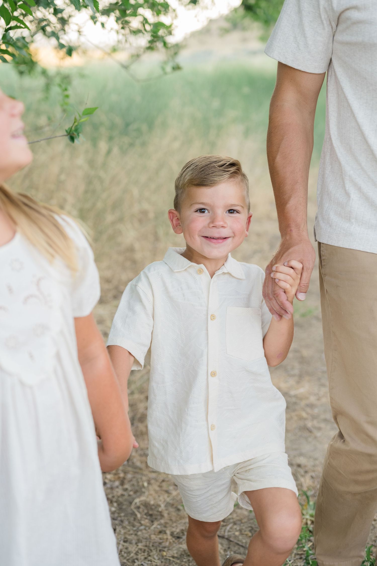Outdoor lifestyle family photo in Boise with warm lighting and neutral outfits.