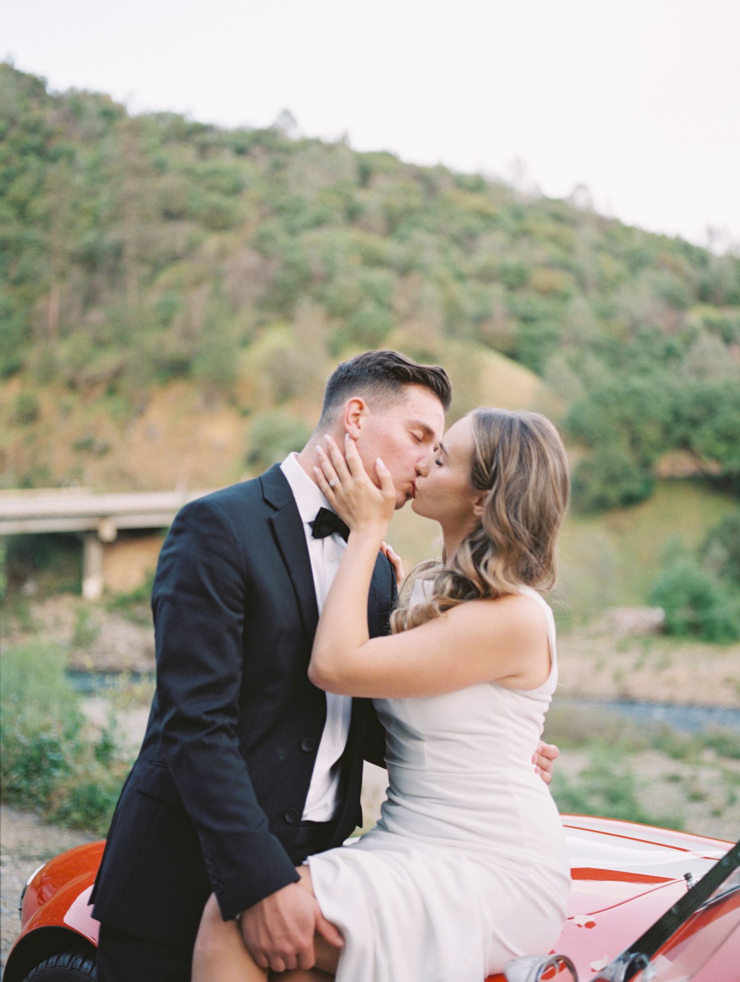 Bride and groom candid moment post-ceremony, warm film tones by Natalya Mark Photo.